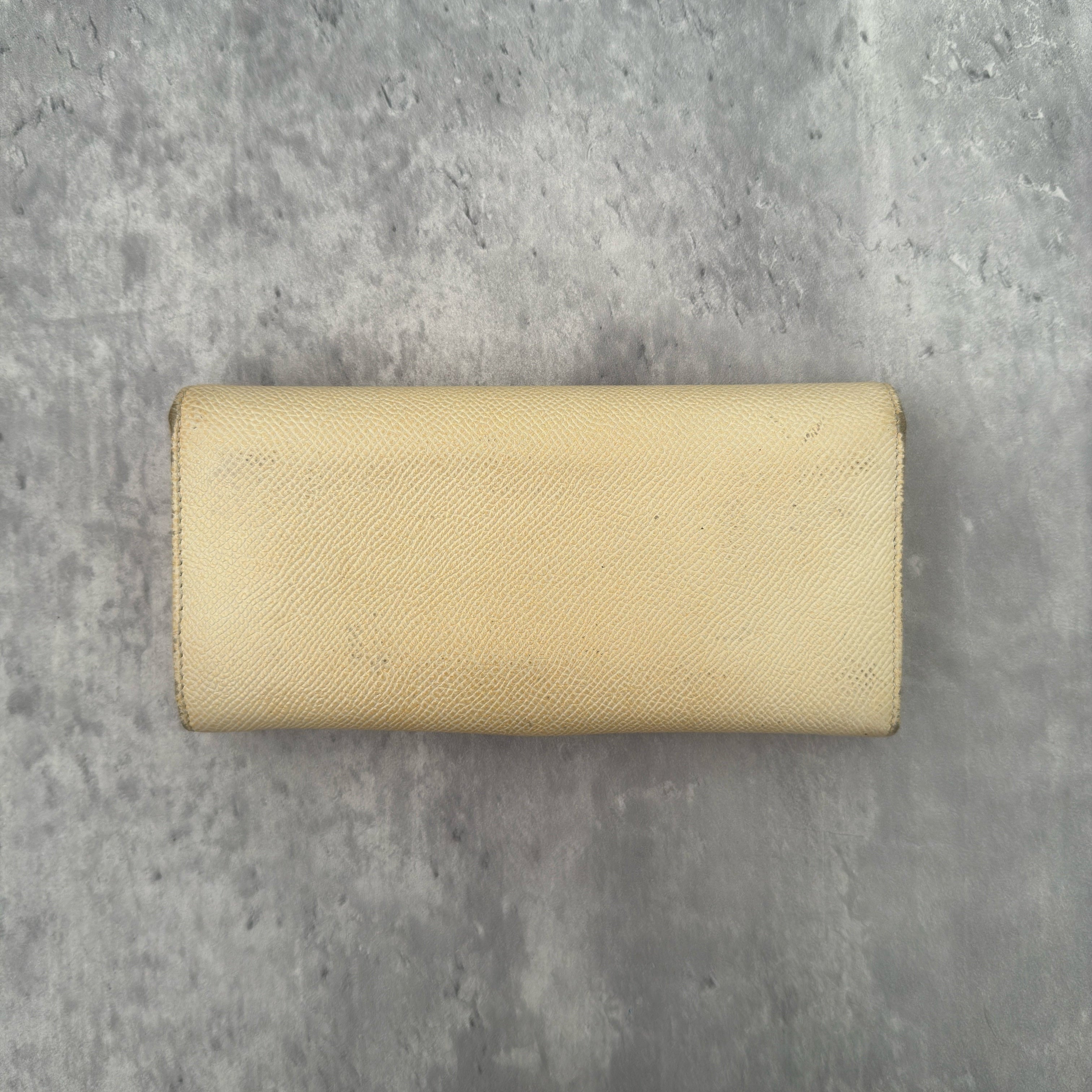 Bvlgari B.Zero1 Beige Saffiano Leather Long Wallet featuring a gold-tone ring clasp and fuchsia pink leather interior.