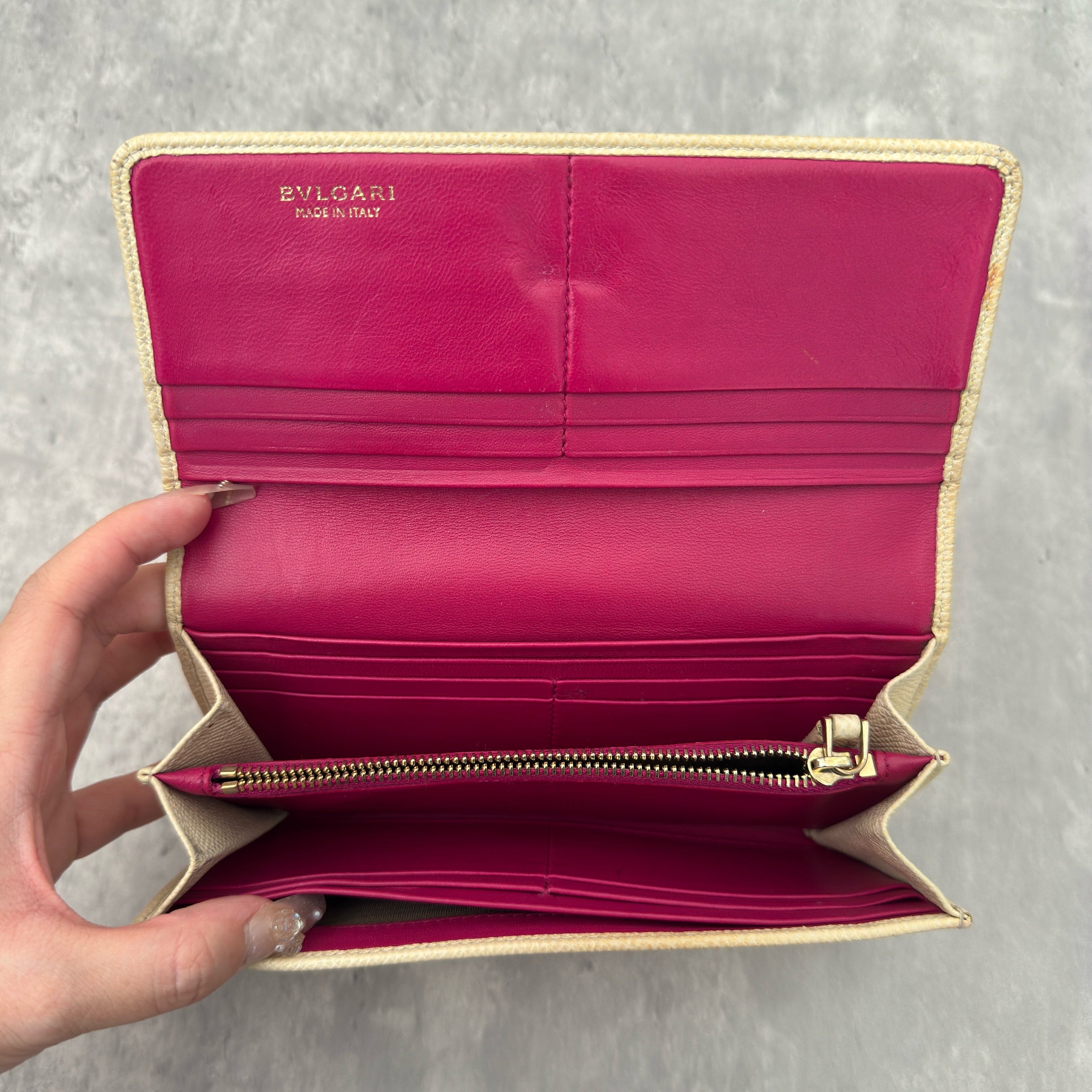 Bvlgari B.Zero1 Beige Saffiano Leather Long Wallet featuring a gold-tone ring clasp and fuchsia pink leather interior.