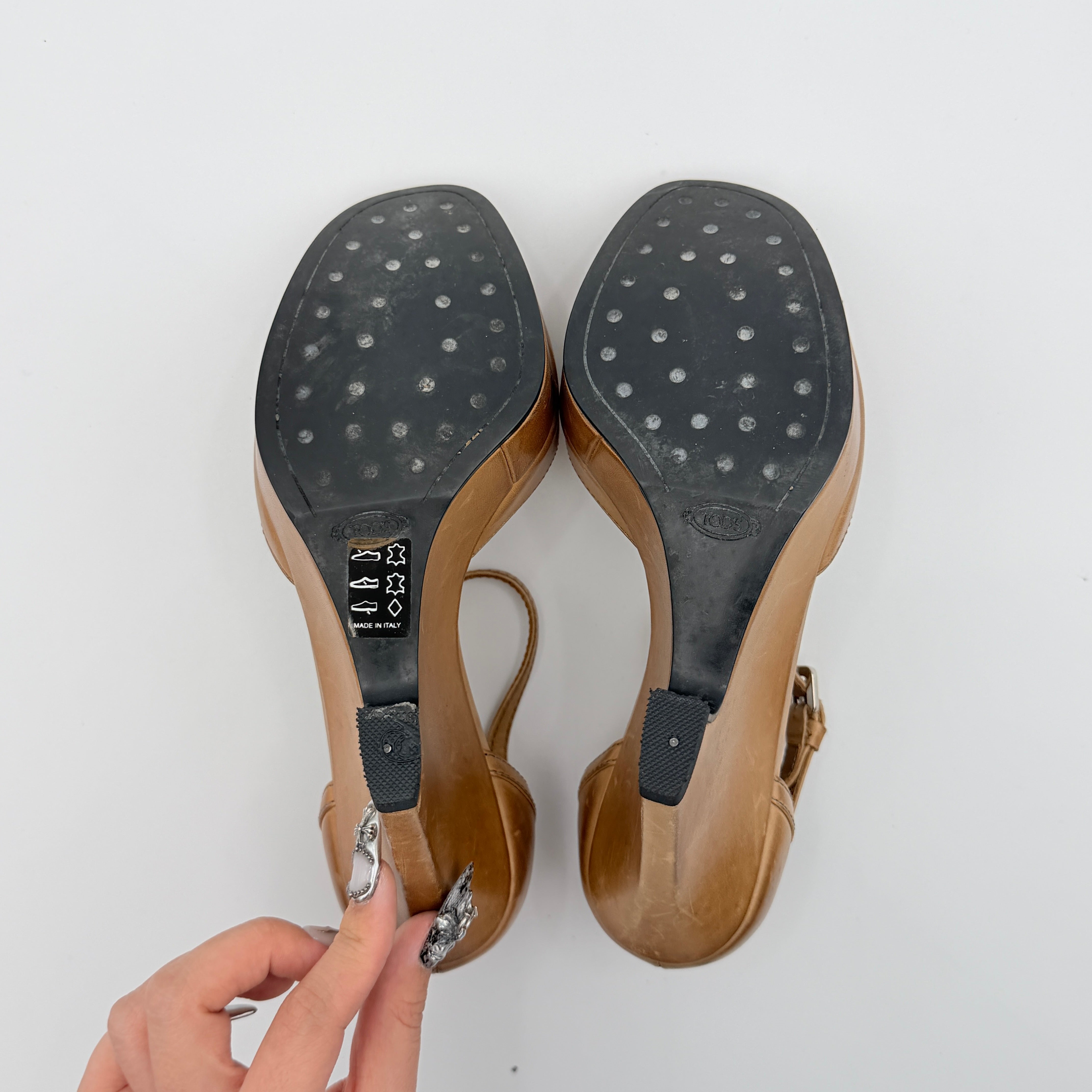 Tan leather Tod's peep-toe platform wedge sandals with ankle strap and front bow detail, shown from an angle.