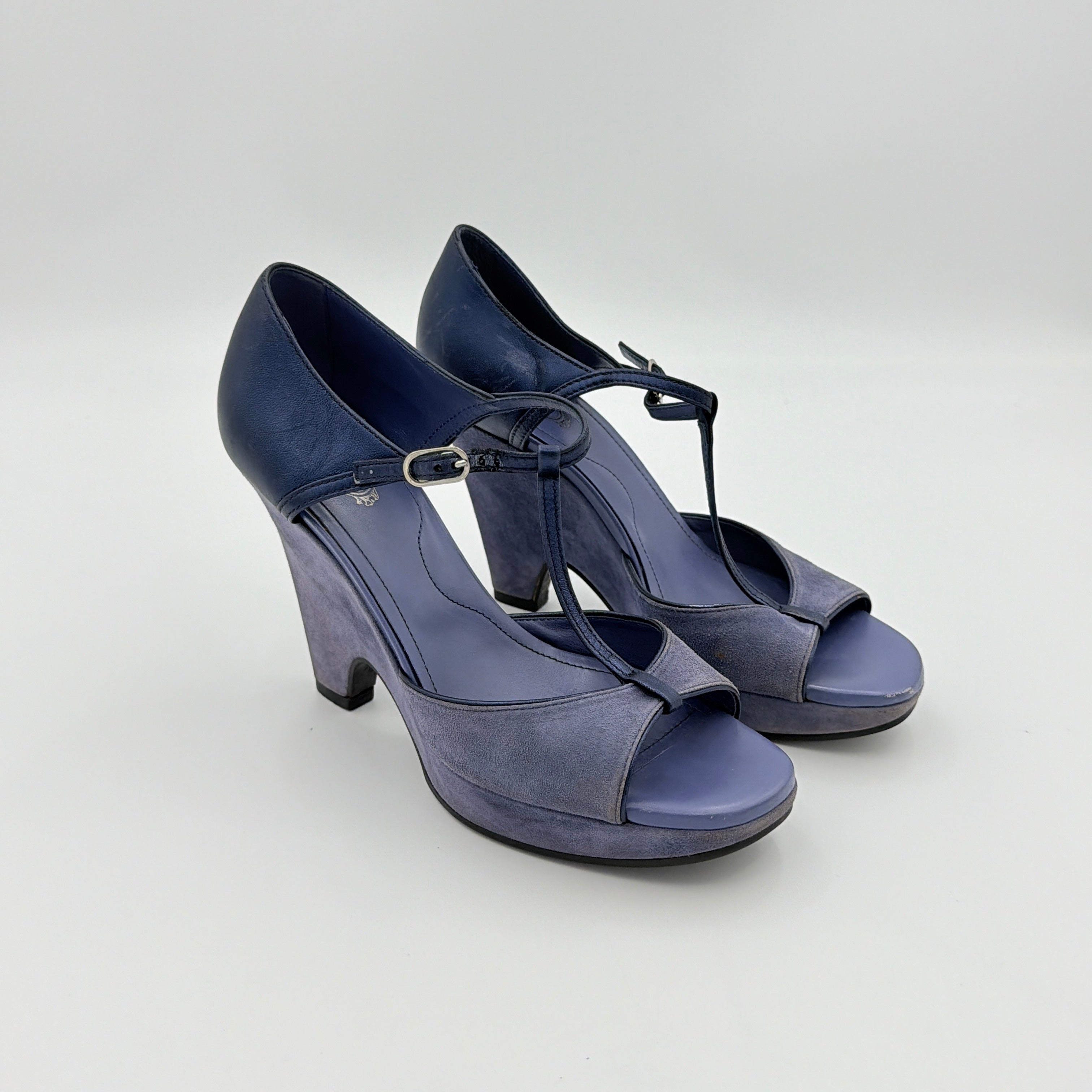 A pair of Tod's blue suede and leather T-strap platform wedge sandals with buckle detail, displayed at an angle.