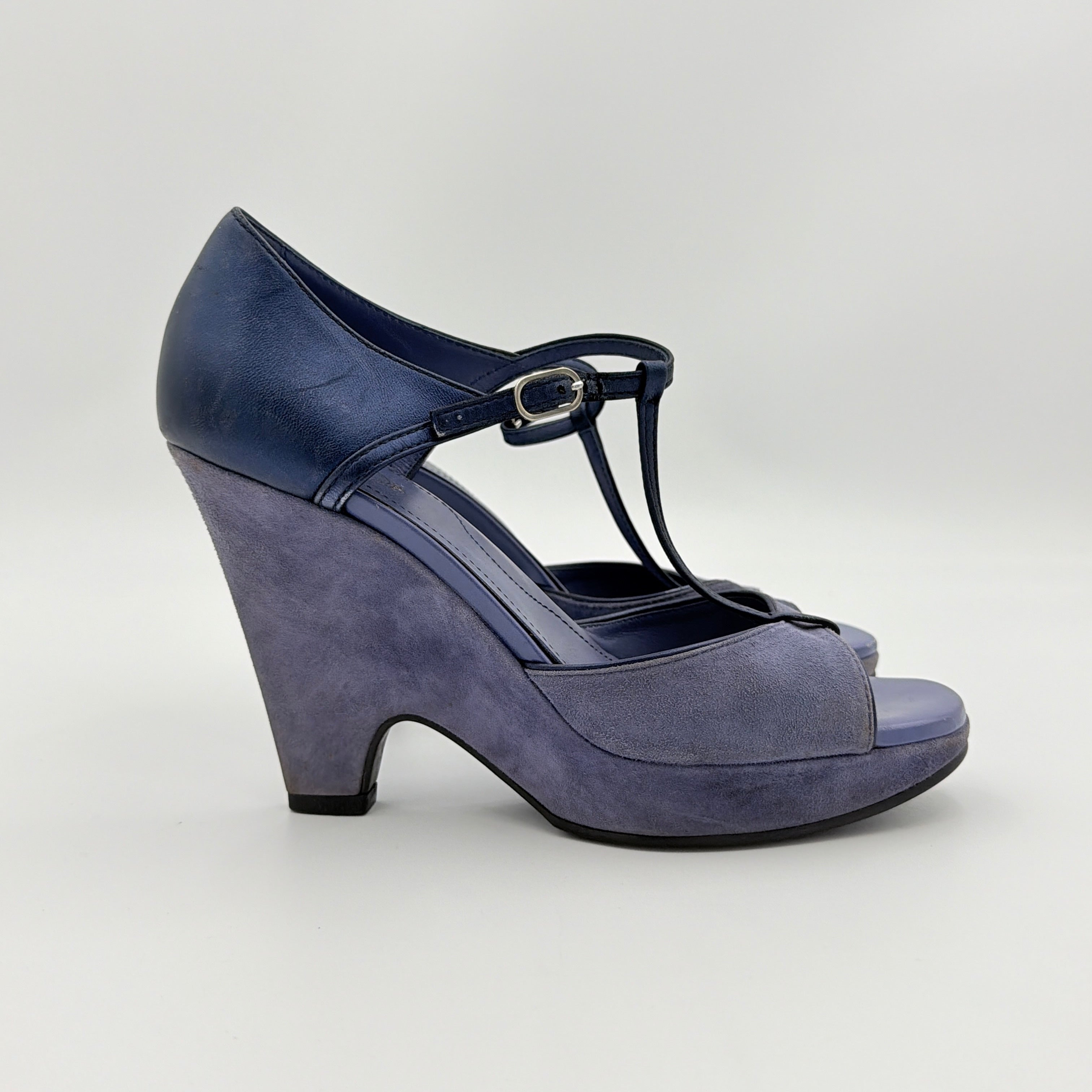 A pair of Tod's blue suede and leather T-strap platform wedge sandals with buckle detail, displayed at an angle.