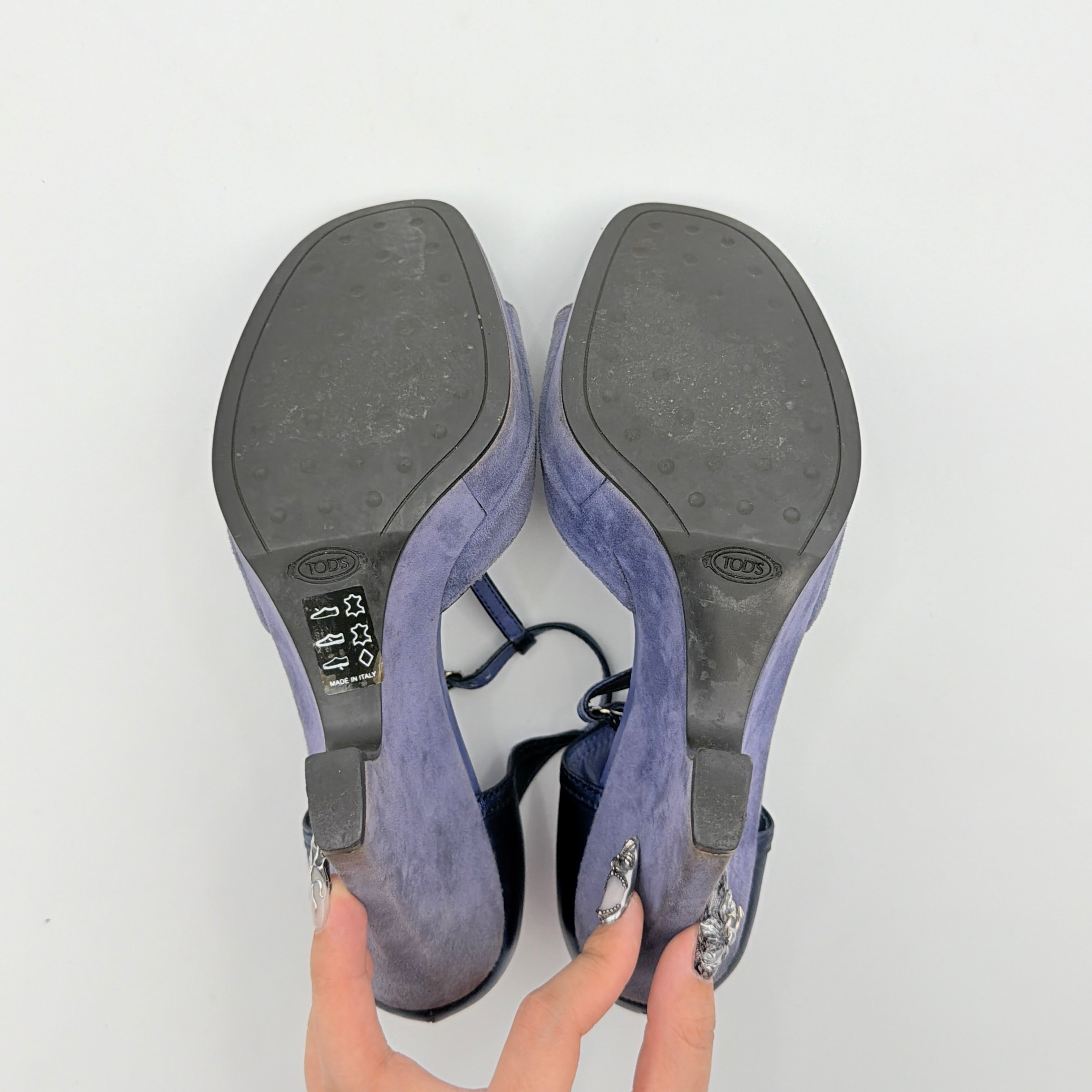A pair of Tod's blue suede and leather T-strap platform wedge sandals with buckle detail, displayed at an angle.
