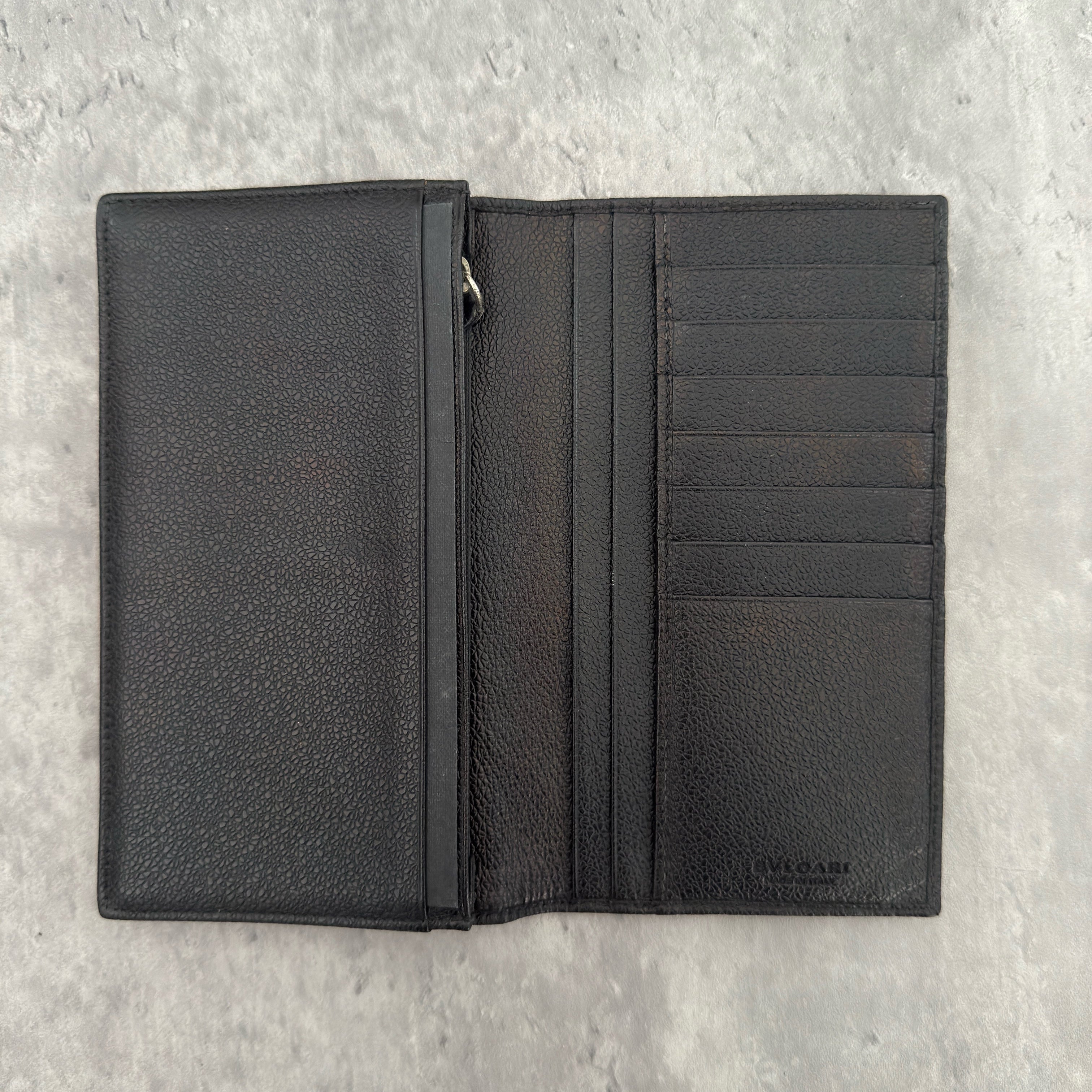 Bvlgari Ribbed Nylon Long Bifold Wallet in black with a silver-tone metal plaque logo, featuring multiple compartments and a sleek ribbed texture.