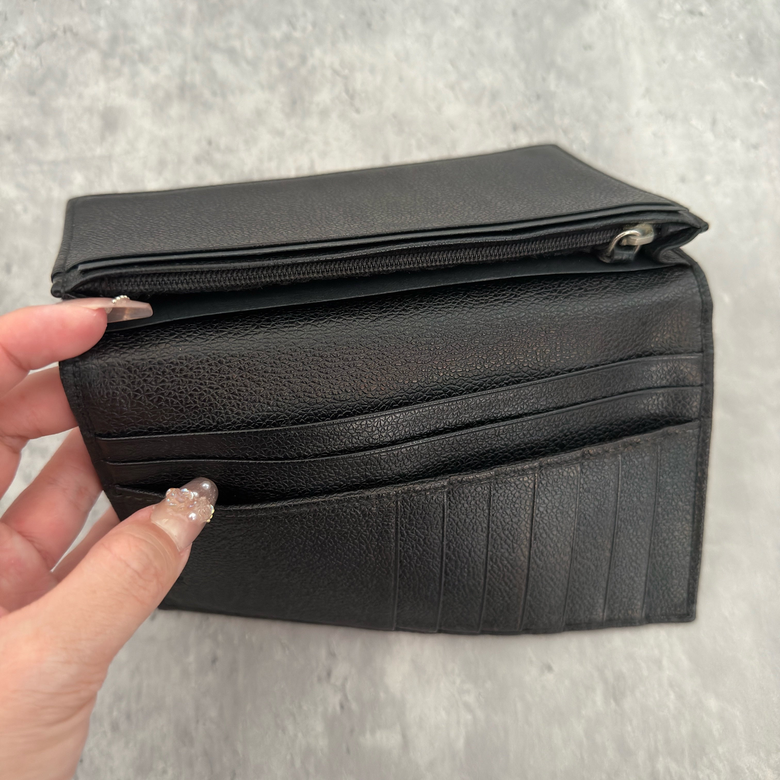 Bvlgari Ribbed Nylon Long Bifold Wallet in black with a silver-tone metal plaque logo, featuring multiple compartments and a sleek ribbed texture.