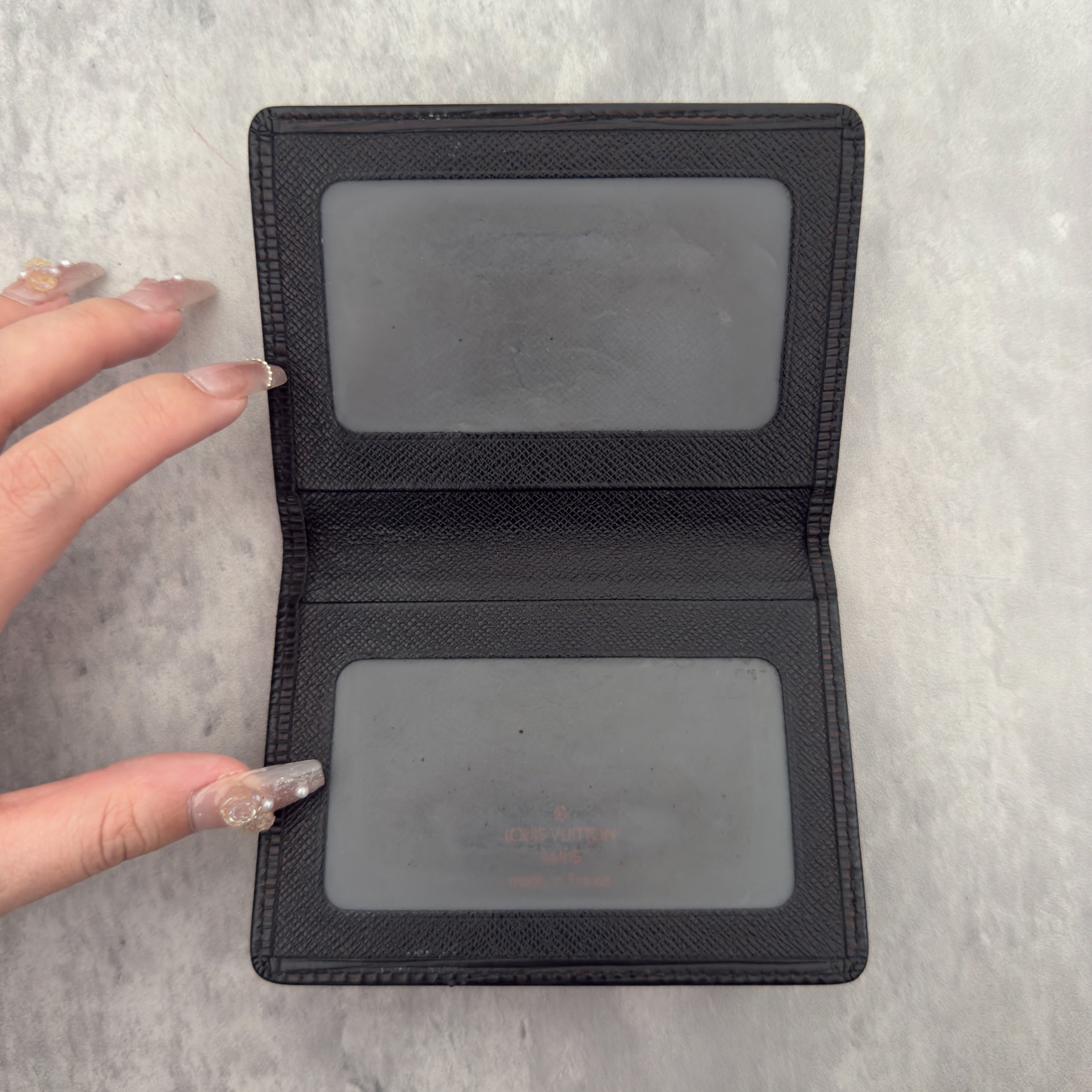 Louis Vuitton Epi Black Cardholder in black Epi leather, featuring dual transparent card slots and a slim, elegant design.