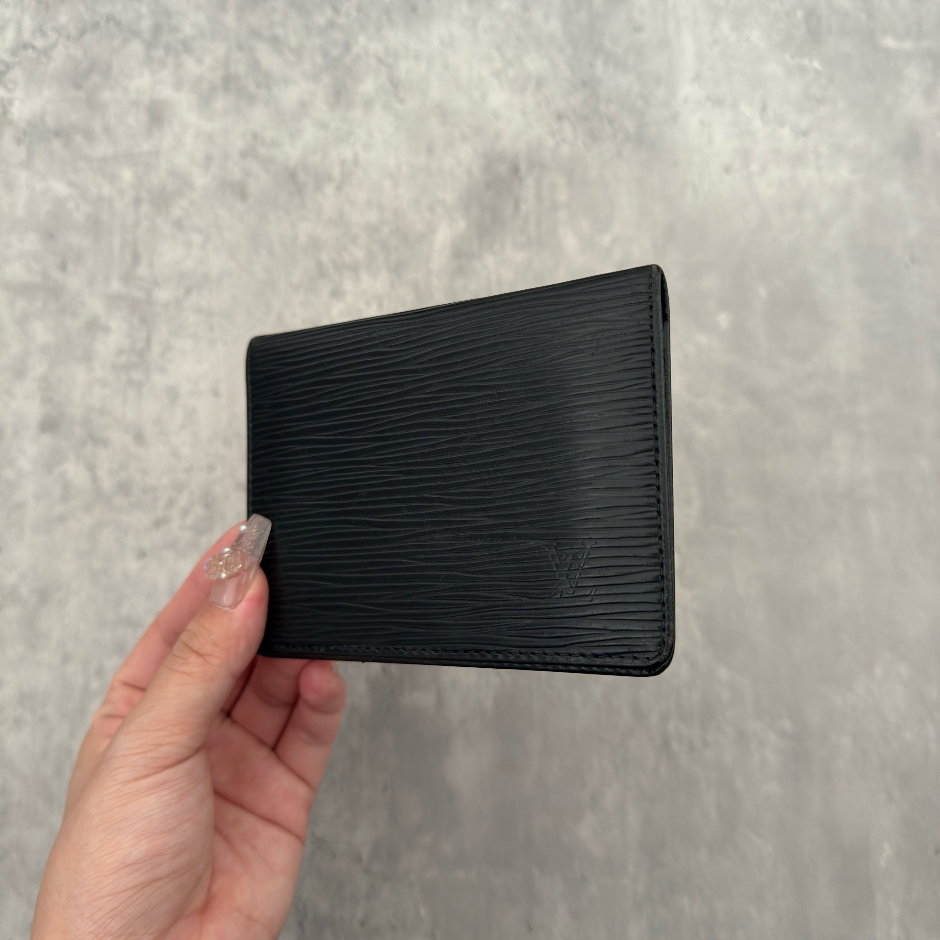 Louis Vuitton Epi Black Cardholder in black Epi leather, featuring dual transparent card slots and a slim, elegant design.