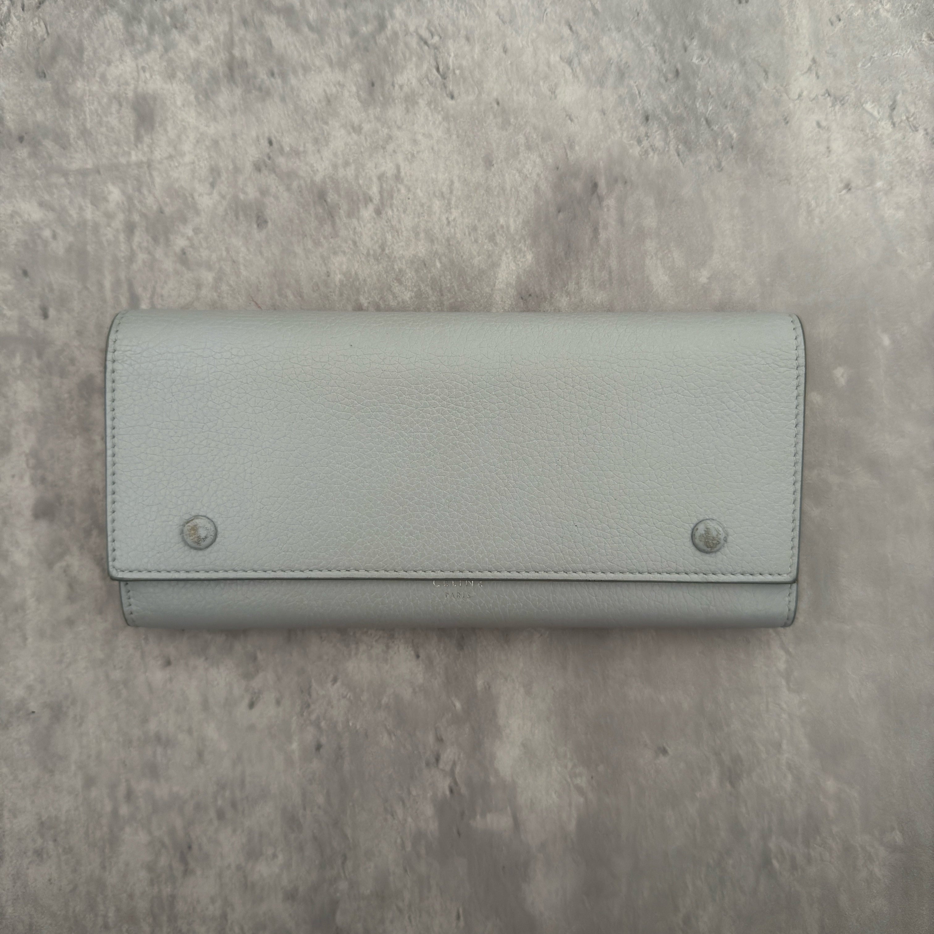 Celine Long Bifold Baby Blue Long Wallet, crafted from grained leather with a clipped button snap closure and spacious interior.