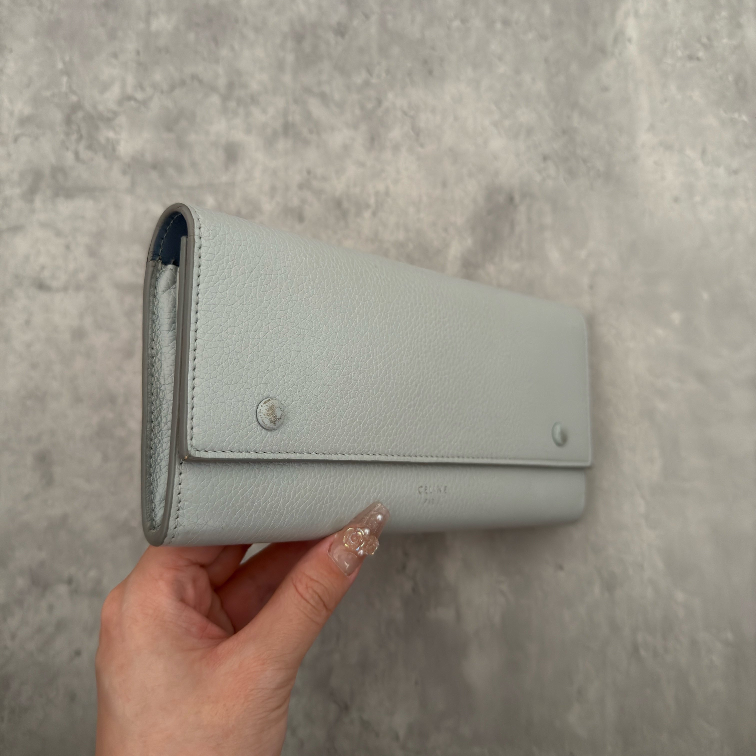 Celine Long Bifold Baby Blue Long Wallet, crafted from grained leather with a clipped button snap closure and spacious interior.
