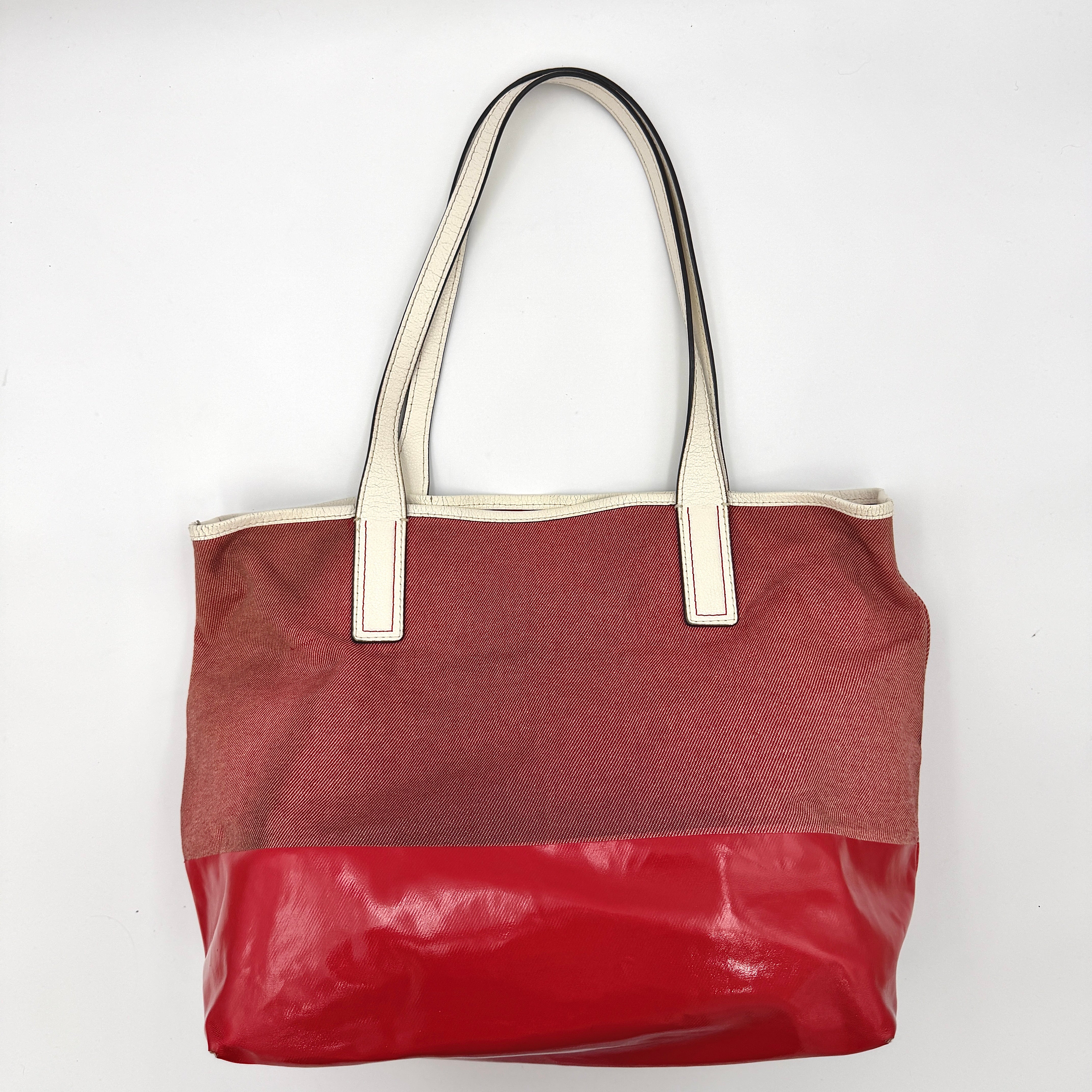 Kate Spade Ash Street Logo Tote in red canvas with glossy red leather base and ivory handles, shown against a white background.