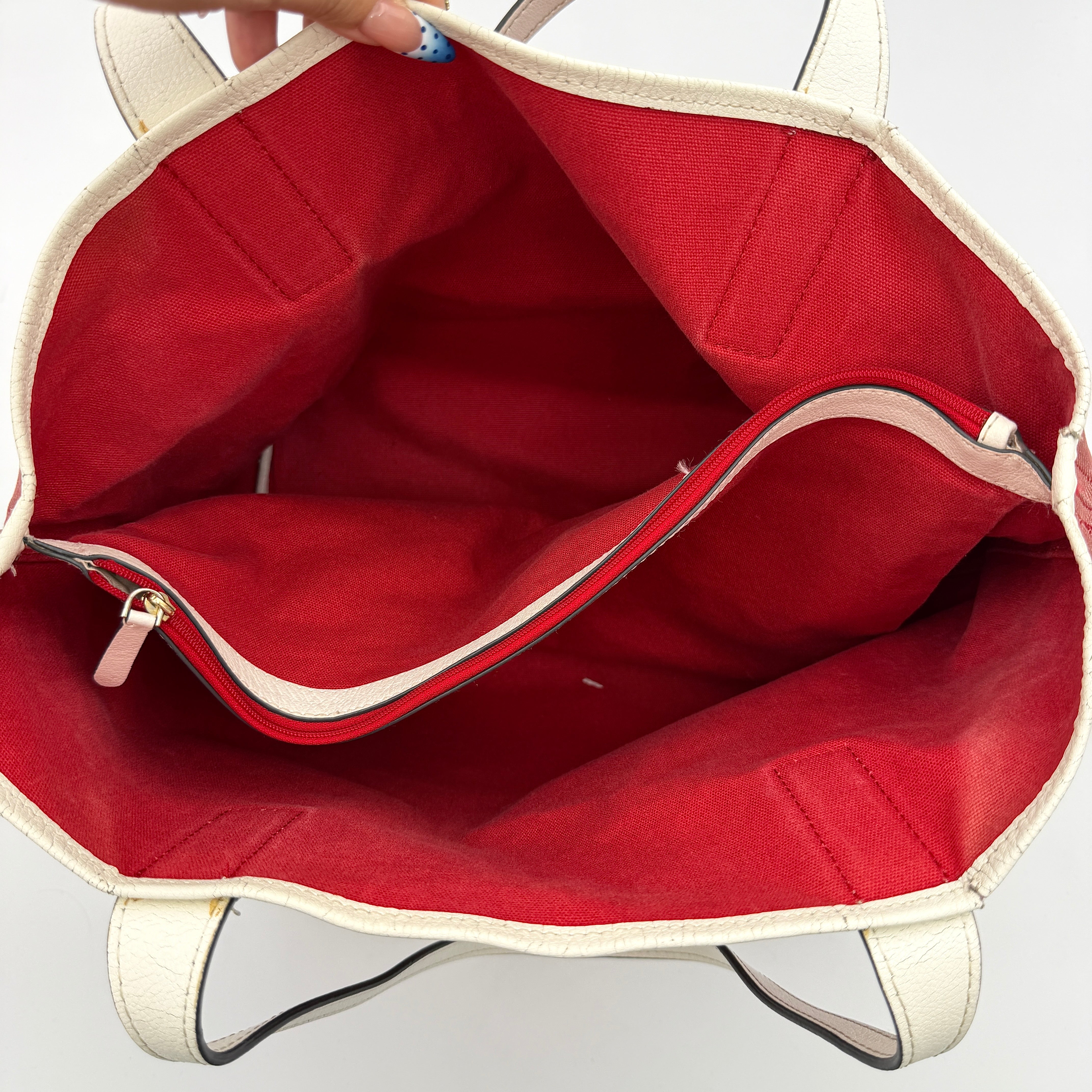 Kate Spade Ash Street Logo Tote in red canvas with glossy red leather base and ivory handles, shown against a white background.