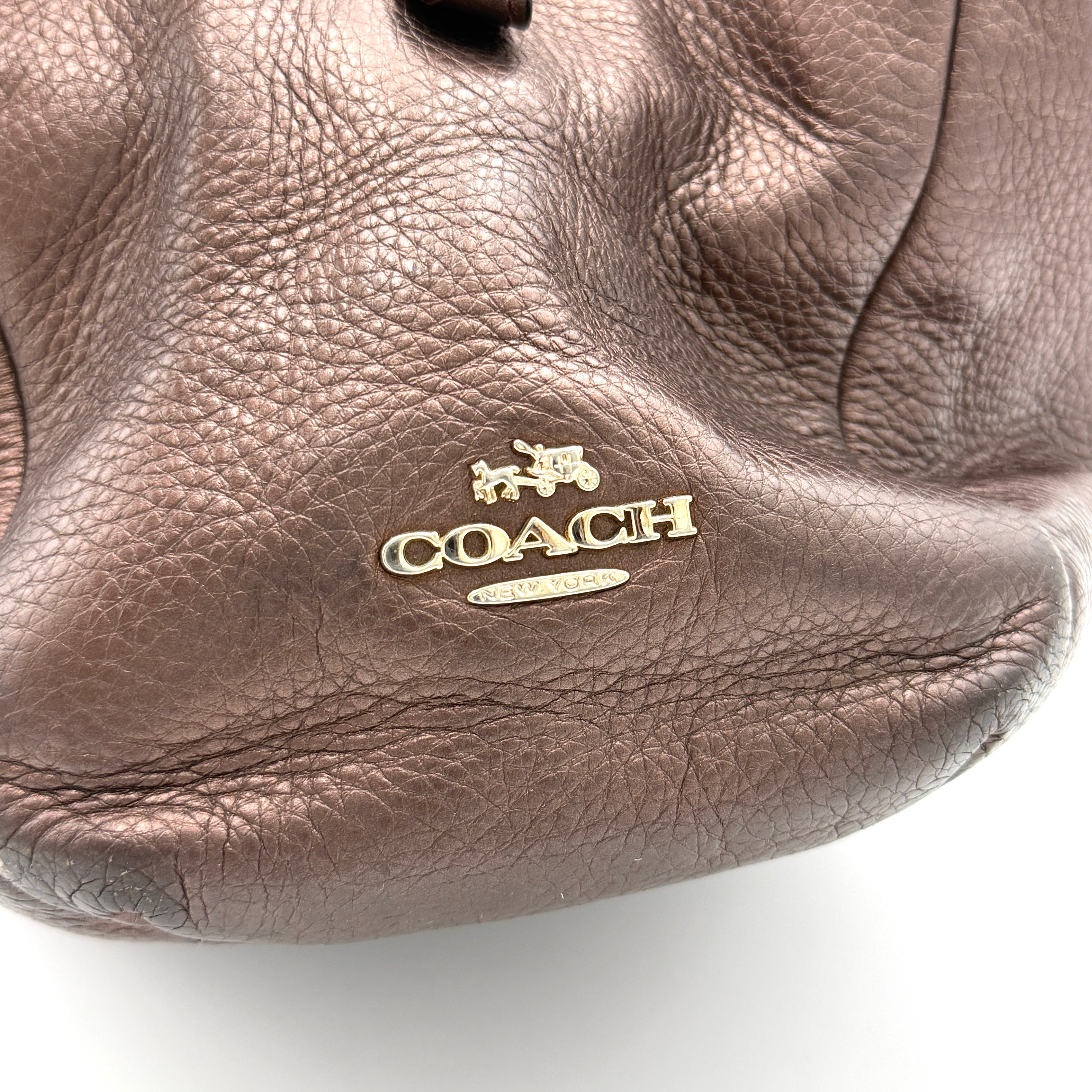 Coach Madison Phoebe Shoulder Bag in rich brown pebbled leather with double shoulder straps and gold-tone hardware, shown upright against a white backdrop.