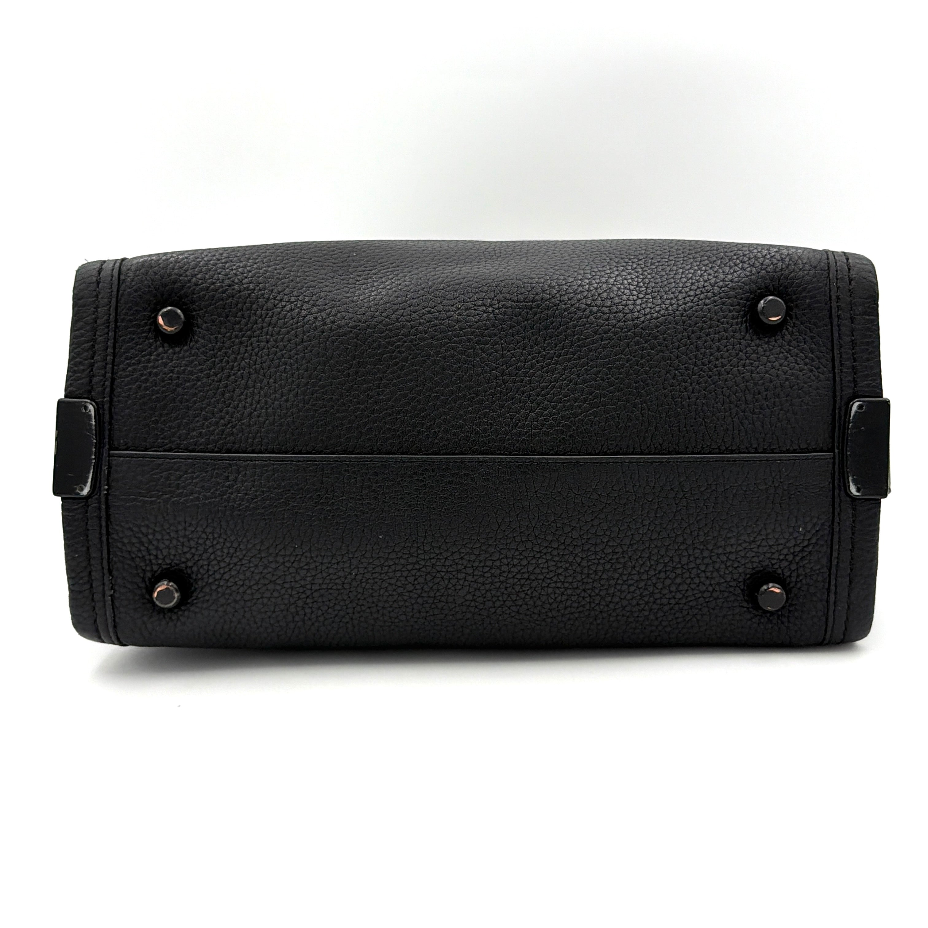 Coach Swagger Carryall handbag in black pebbled leather with matte black hardware and a vibrant orange butterfly charm.