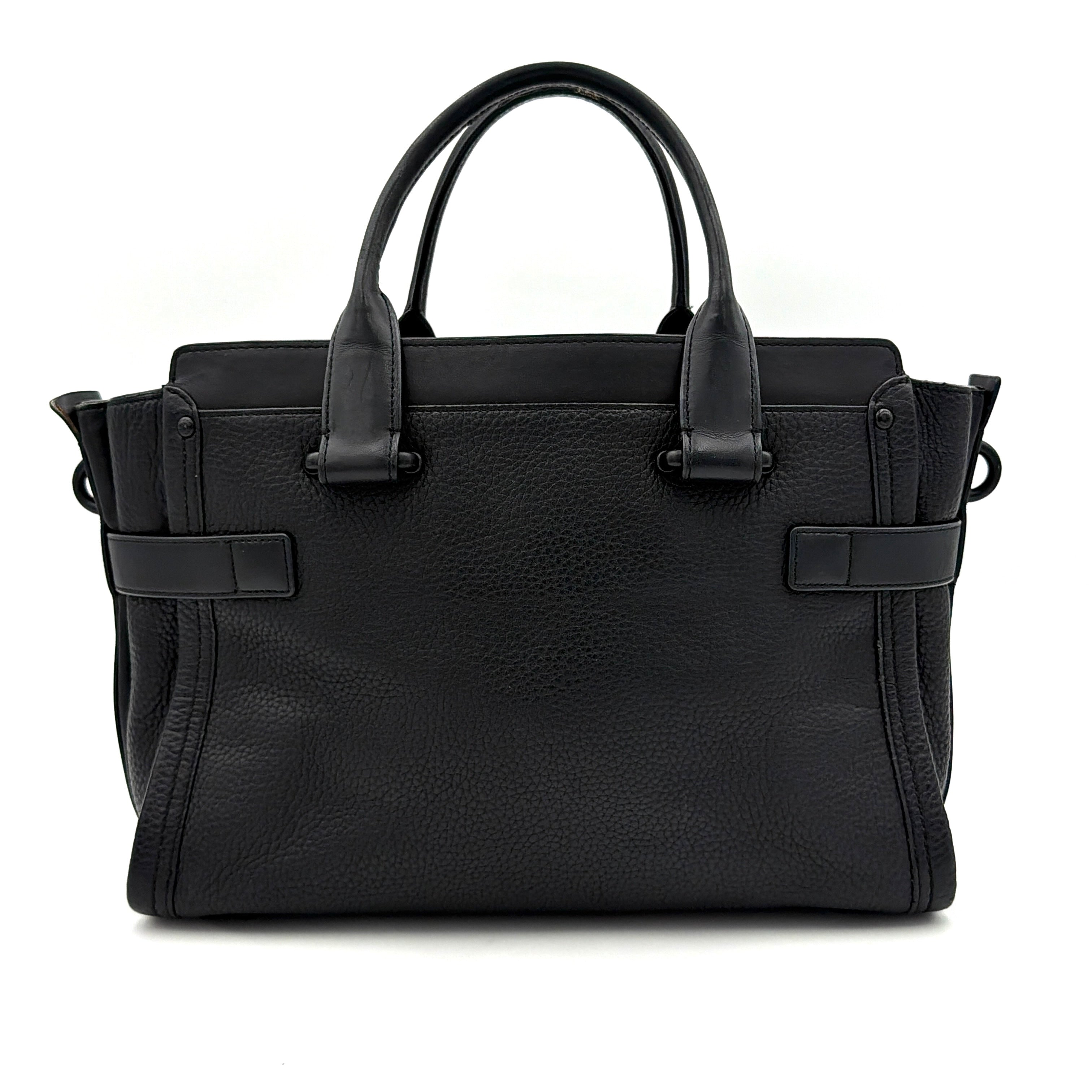 Coach Swagger Carryall handbag in black pebbled leather with matte black hardware and a vibrant orange butterfly charm.