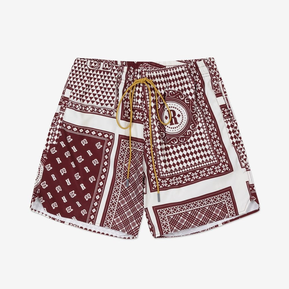 Rhude maroon and white swim shorts with a card print pattern and yellow drawstring, presented flat.
