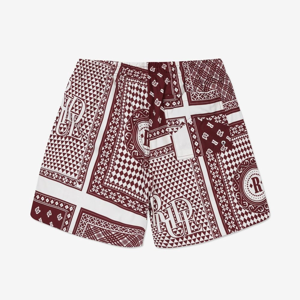 Rhude maroon and white swim shorts with a card print pattern and yellow drawstring, presented flat.