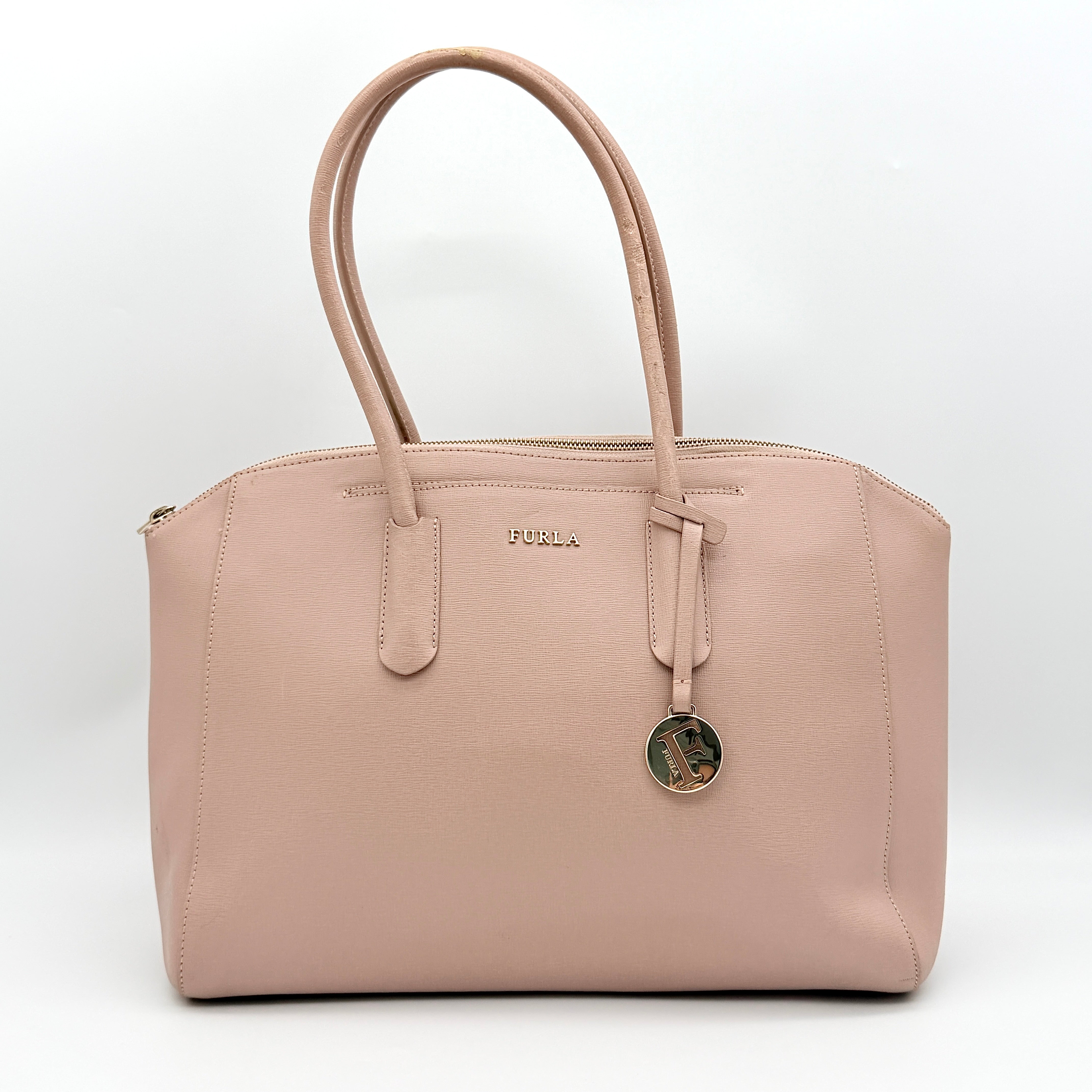 Furla Tessa handbag in light pink leather with gold hardware and double top handles.