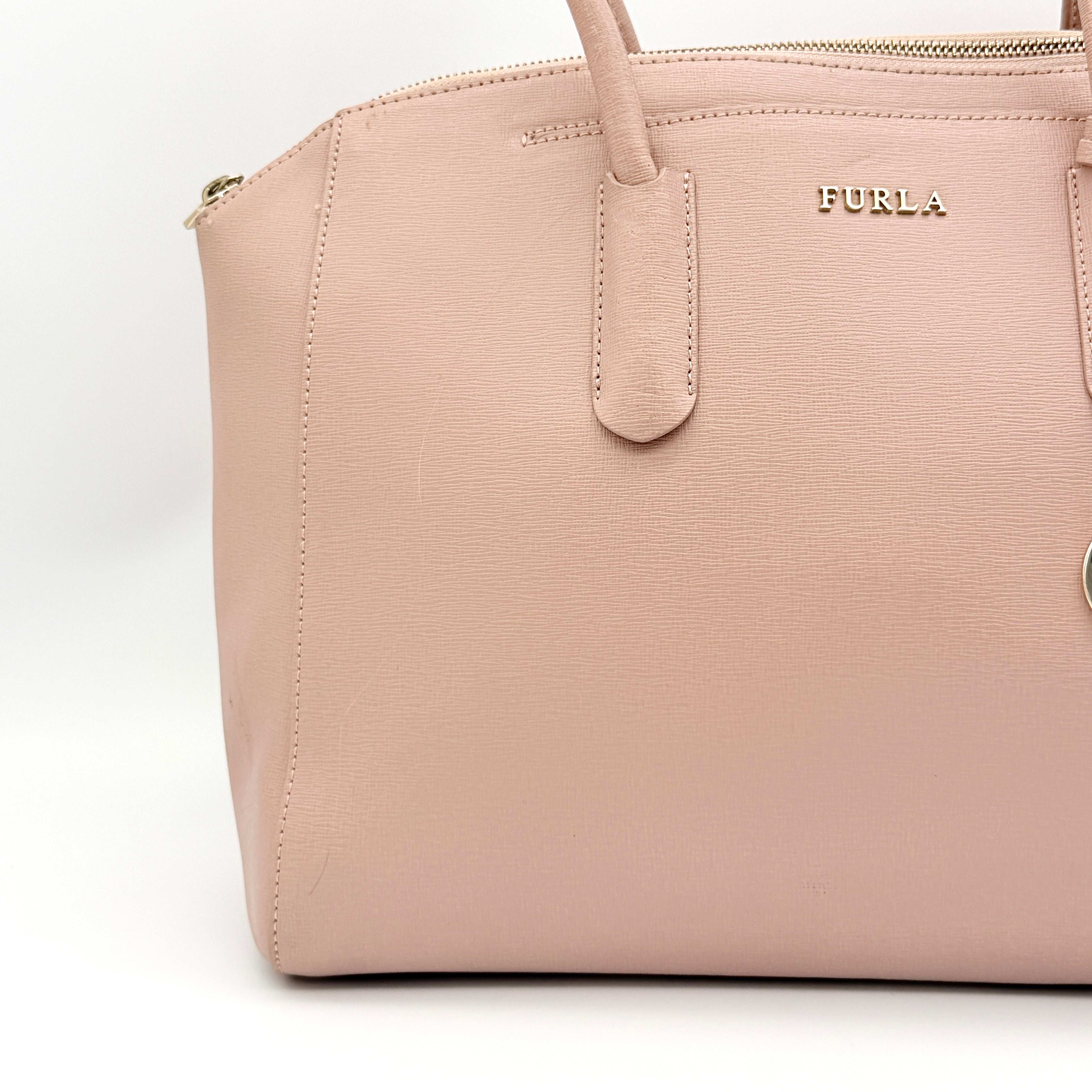 Furla Tessa handbag in light pink leather with gold hardware and double top handles.
