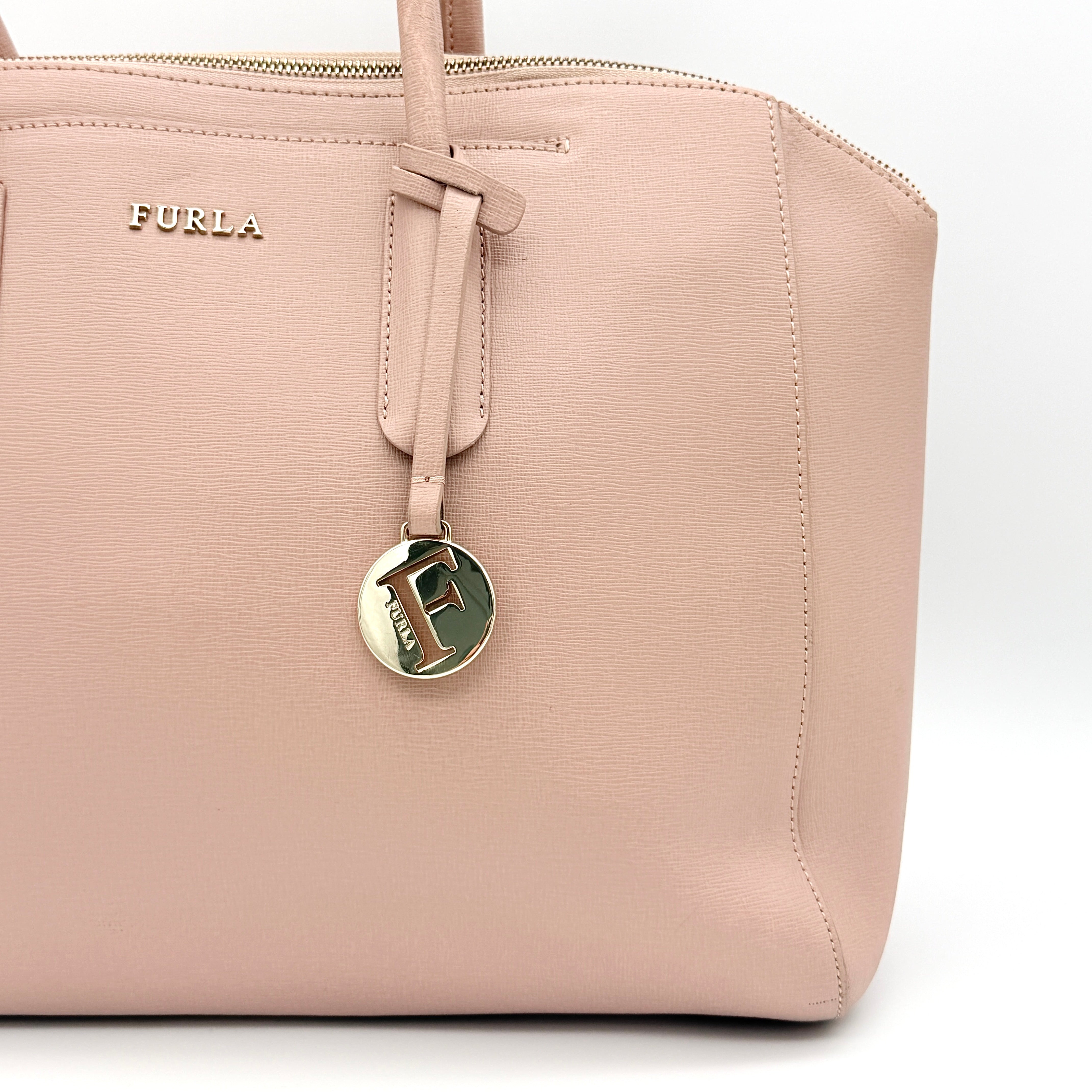 Furla Tessa handbag in light pink leather with gold hardware and double top handles.
