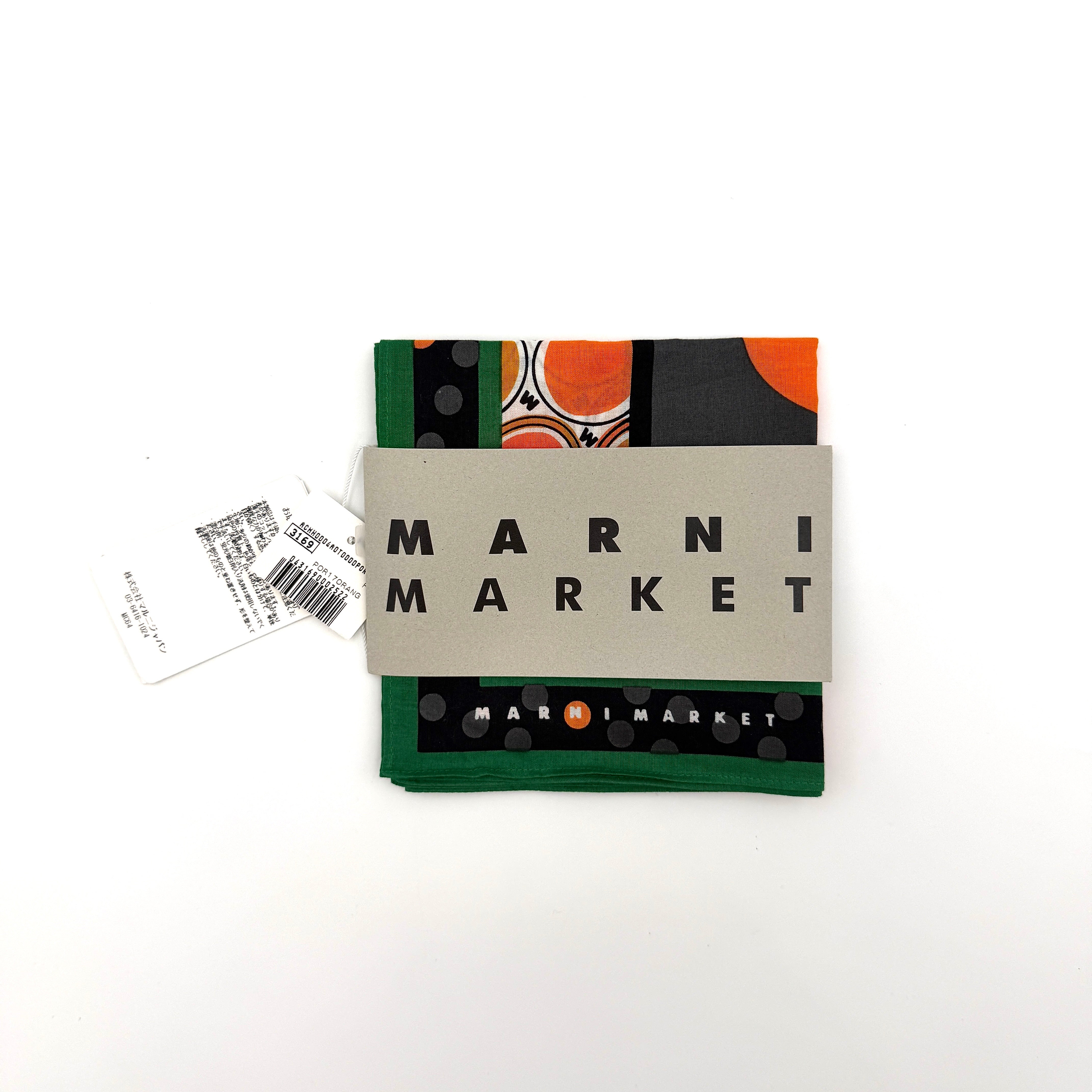 A Marni Market square scarf in orange polka dots and geometric borders with green edges, neatly laid out to show its graphic pattern.