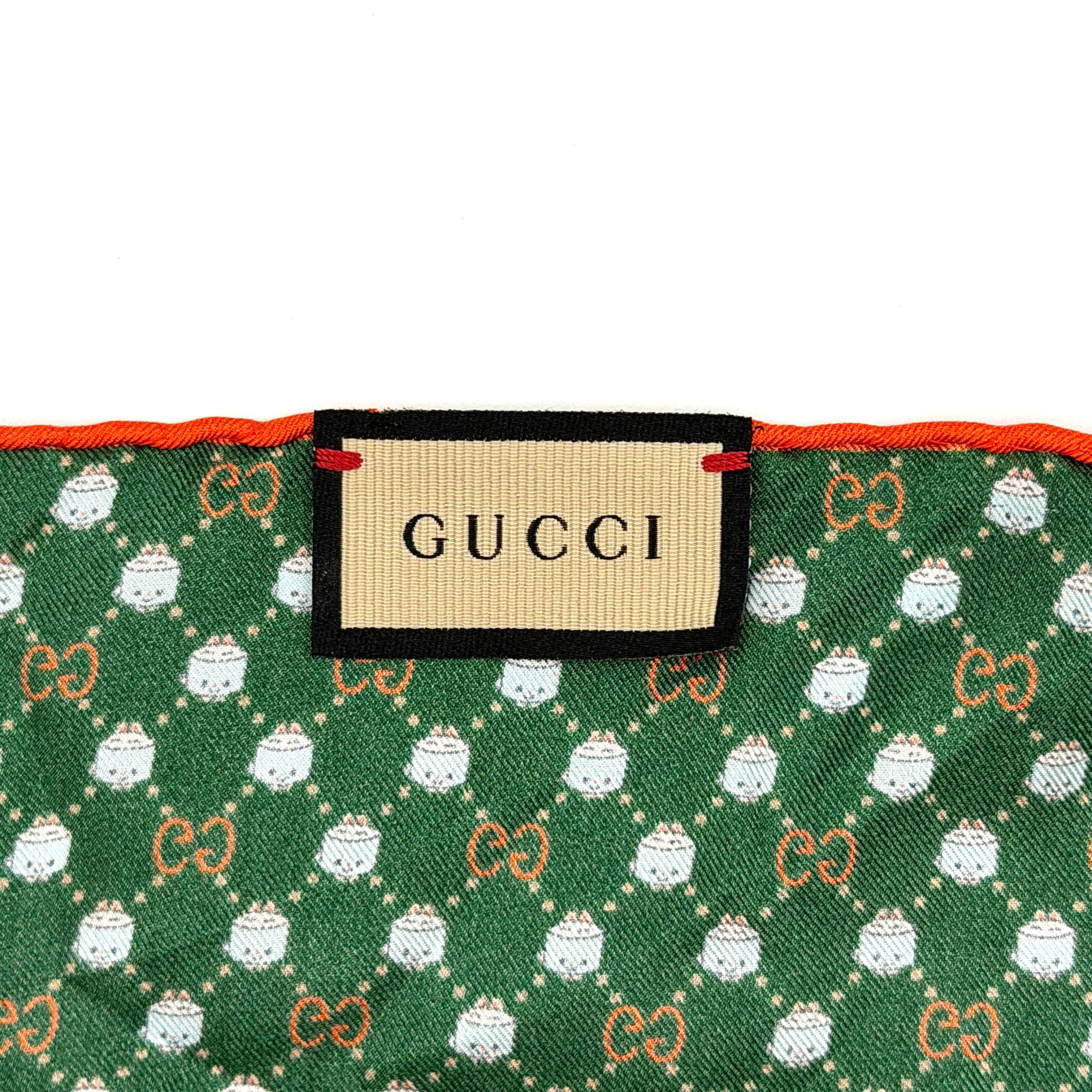 Gucci GG Monogram Silk Scarf in green silk, featuring a playful allover GG pattern and orange rolled edge.