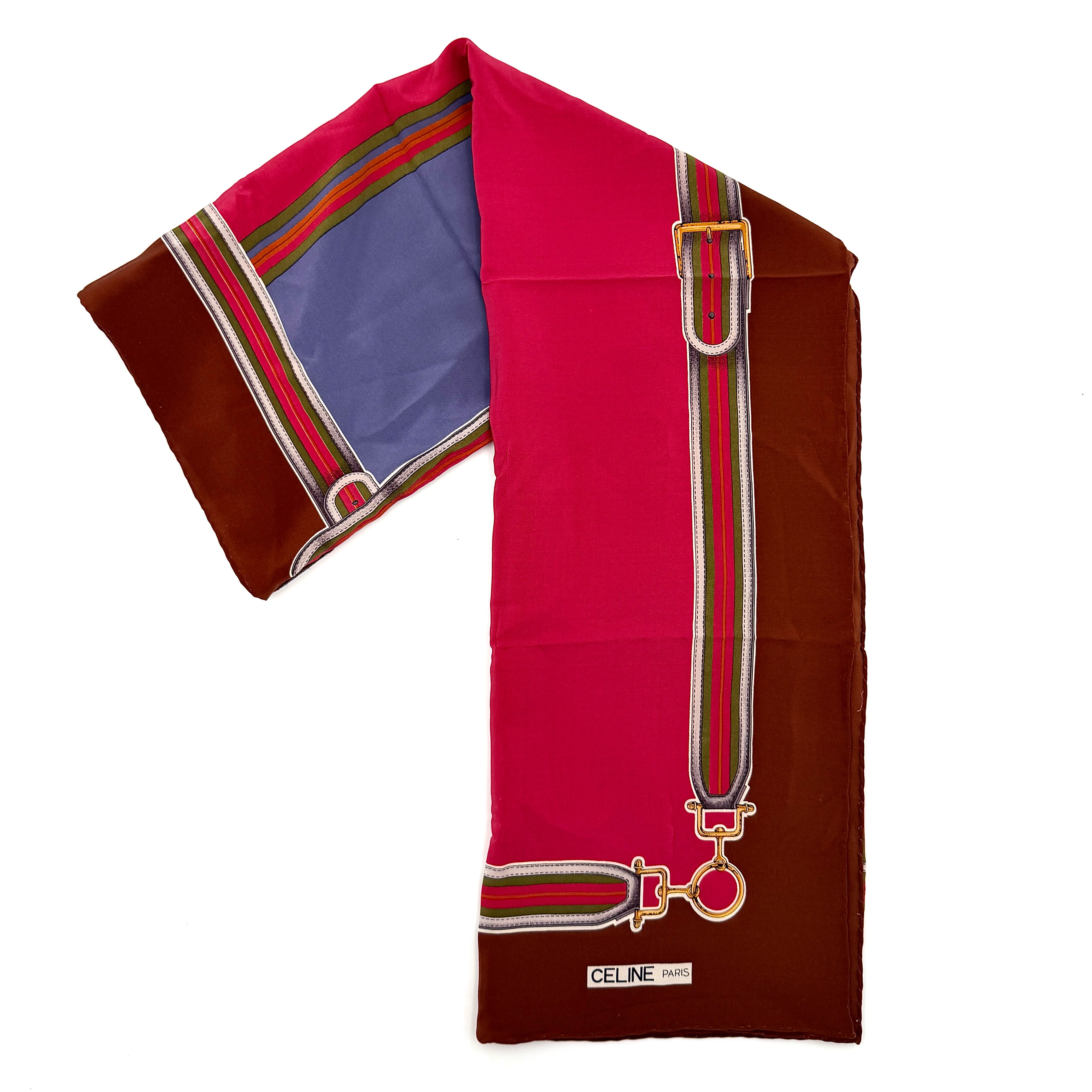 Celine silk scarf in raspberry pink, periwinkle blue, and brown with illustrated buckle and strap motifs.