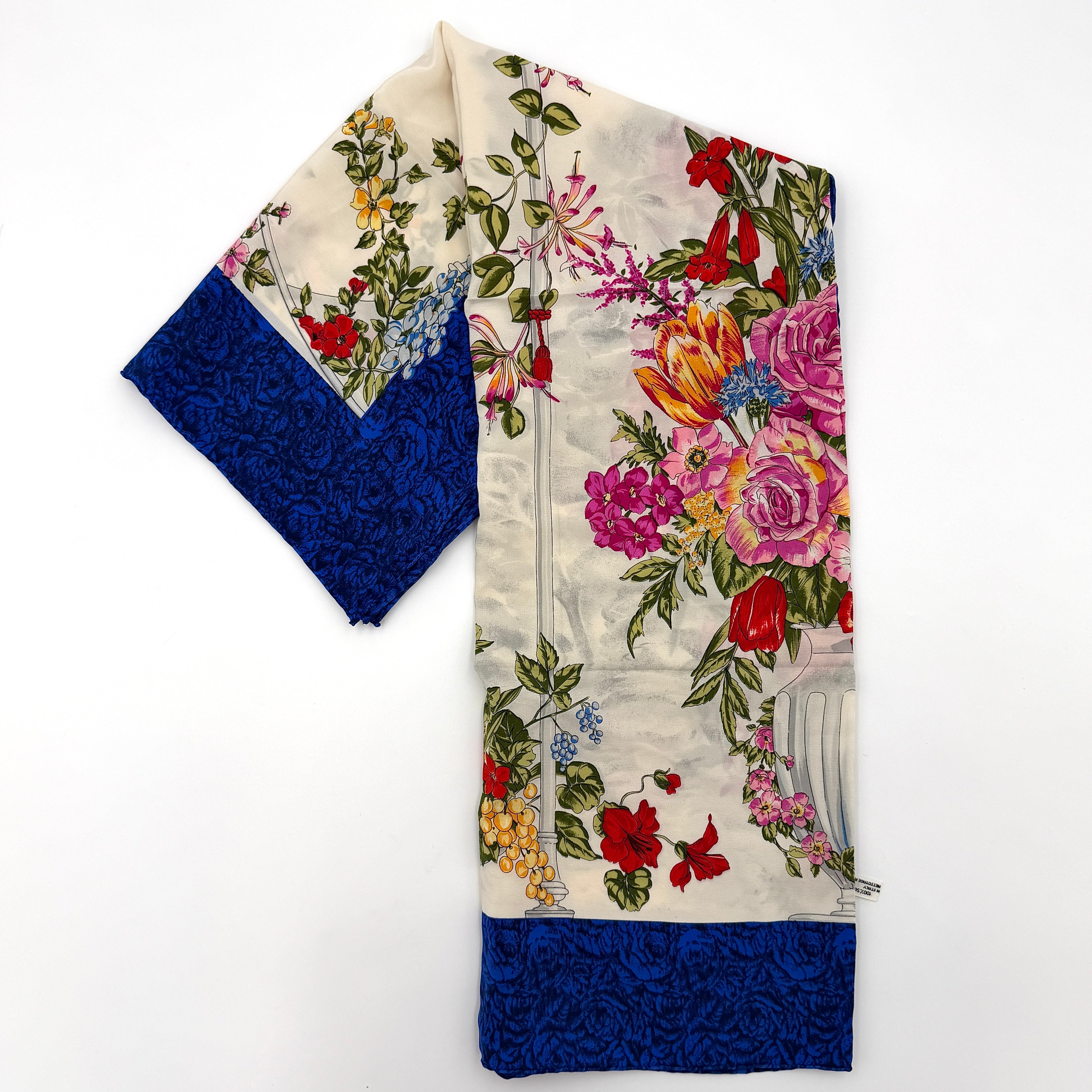Dior silk scarf featuring an ornate multicolour floral print with a deep blue border.