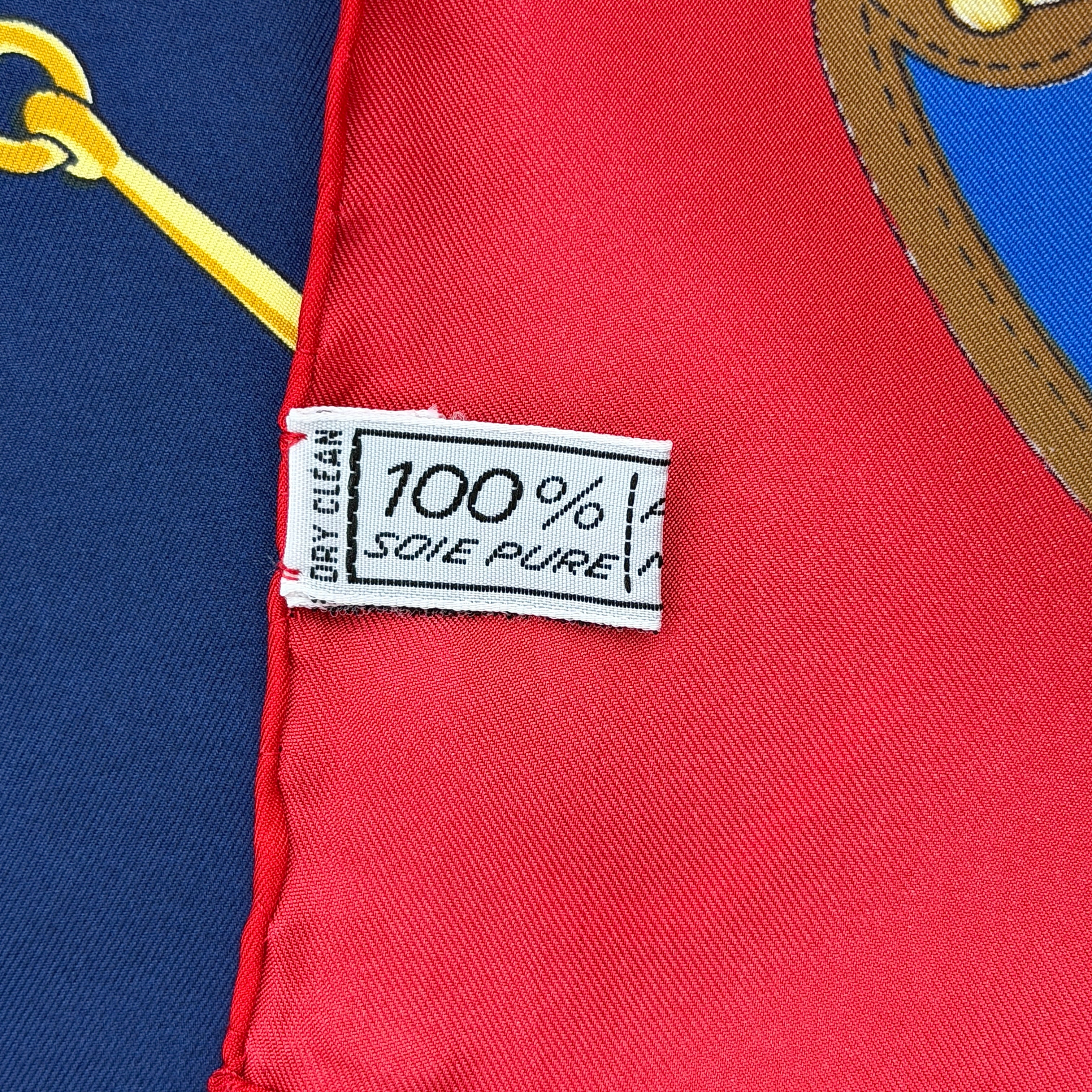 Celine silk scarf featuring a bold equestrian motif in navy, red, green, and gold.