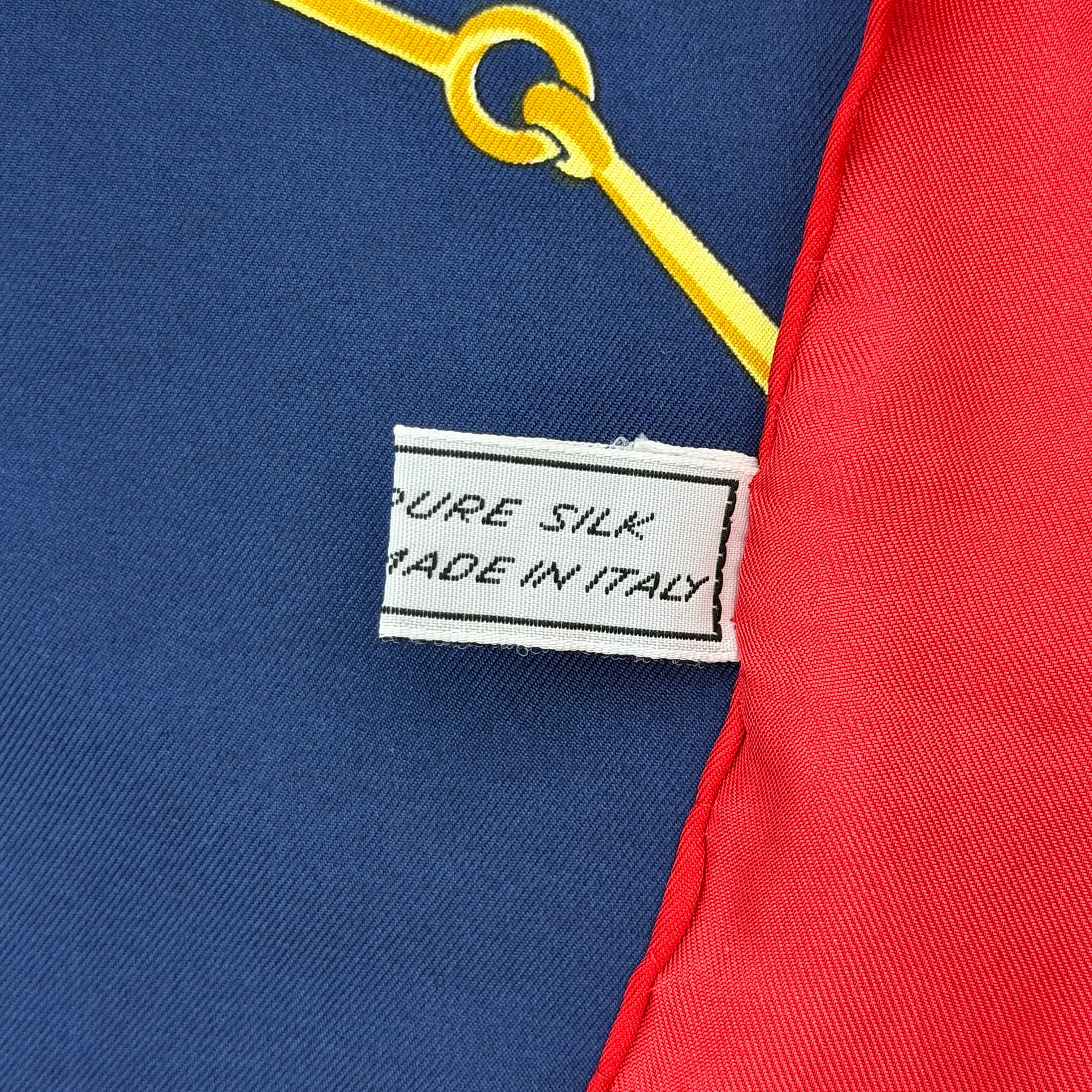 Celine silk scarf featuring a bold equestrian motif in navy, red, green, and gold.