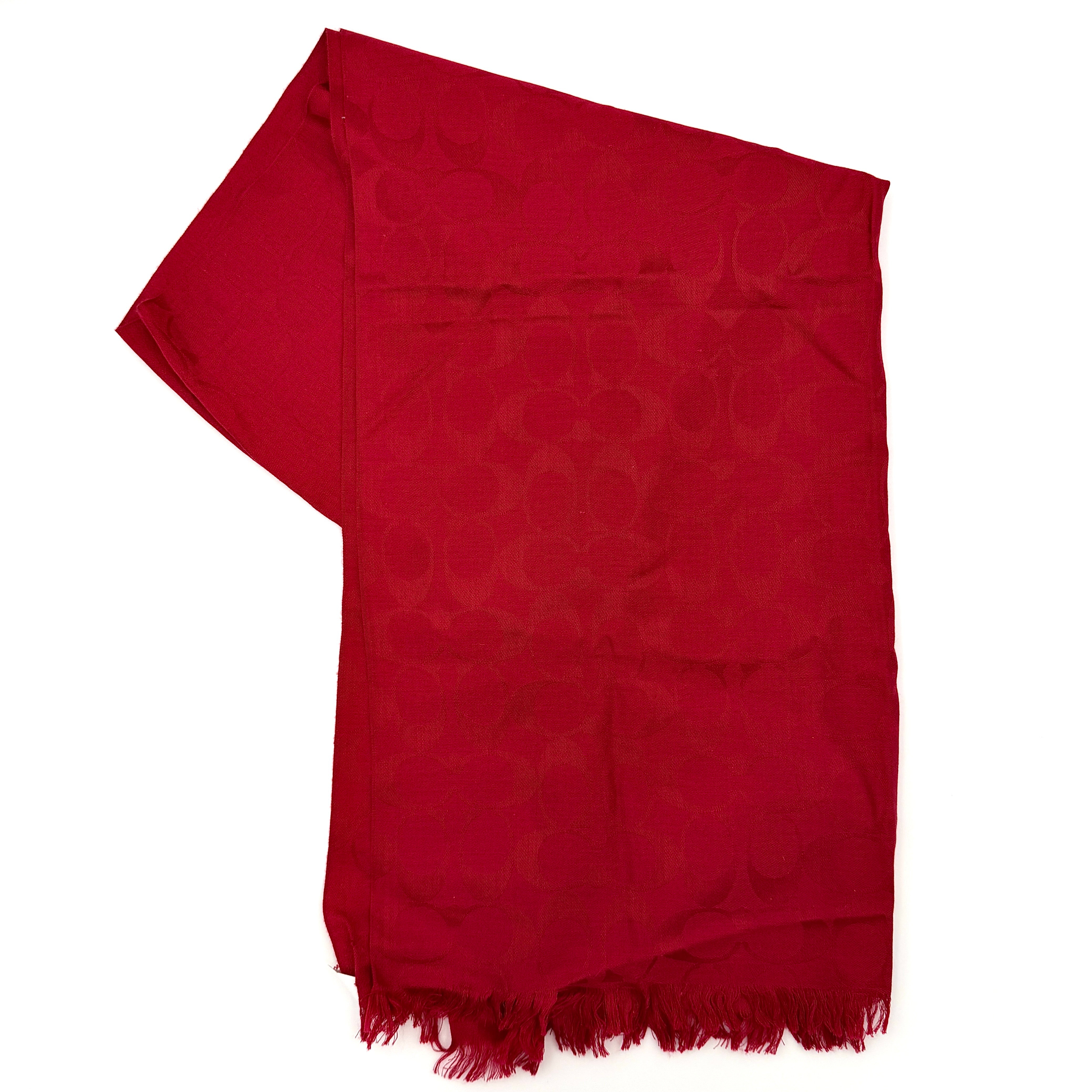 Coach Signature Monogram Wool Scarf in vibrant red wool and silk with tonal logo pattern and delicate fringe edging.