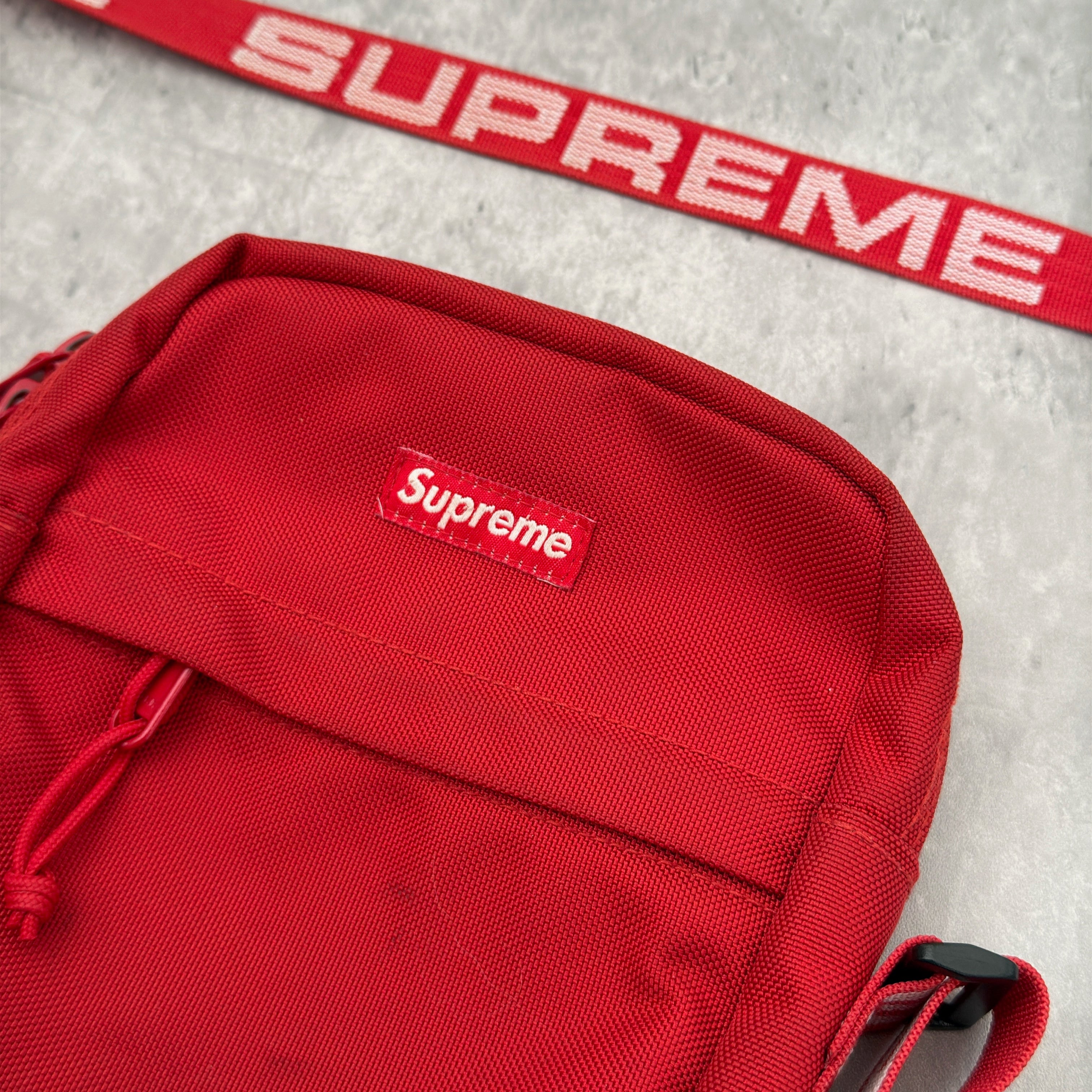 Supreme Shoulder Bag Red (SS18), made from Cordura® fabric with an adjustable Supreme-branded strap and zippered compartments.