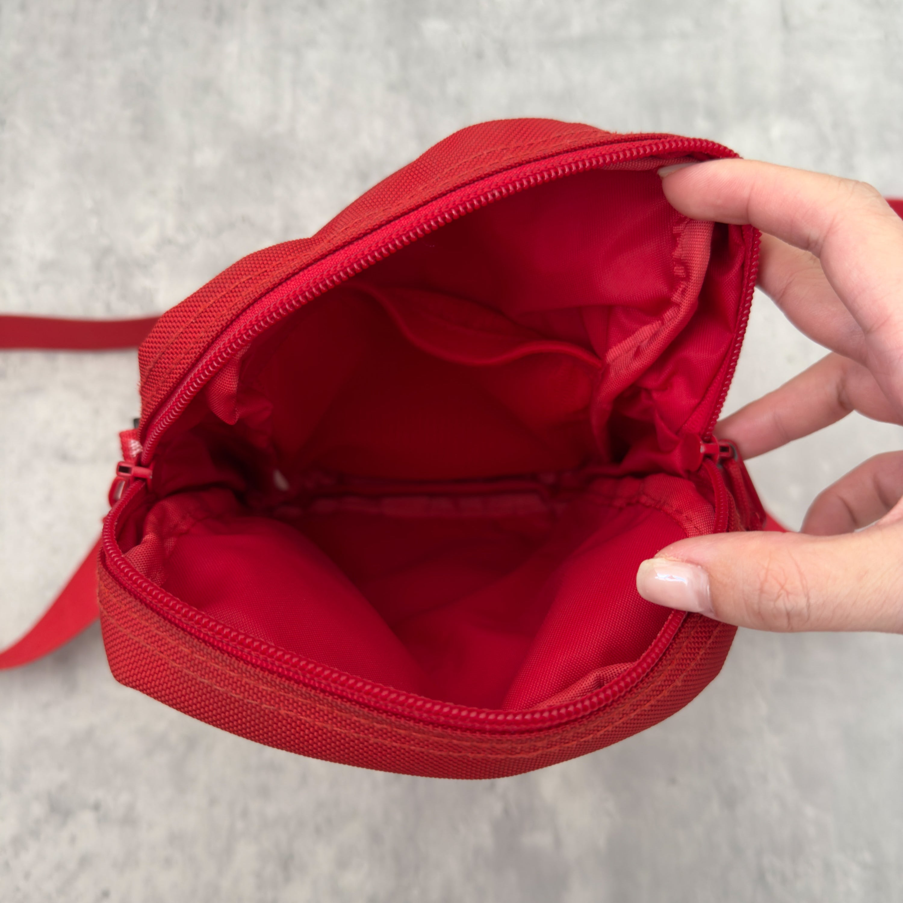 Supreme Shoulder Bag Red (SS18), made from Cordura® fabric with an adjustable Supreme-branded strap and zippered compartments.