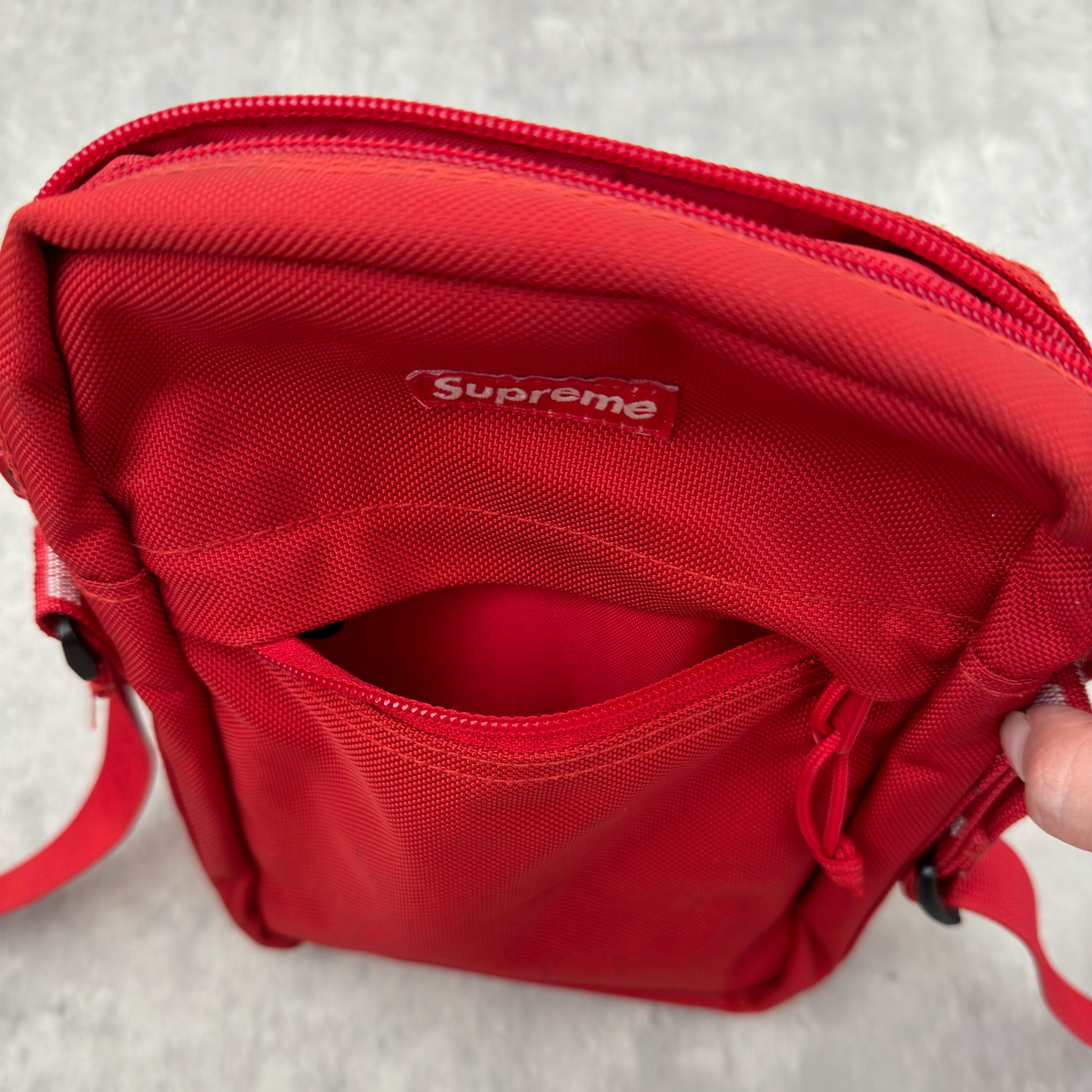 Supreme Shoulder Bag Red (SS18), made from Cordura® fabric with an adjustable Supreme-branded strap and zippered compartments.