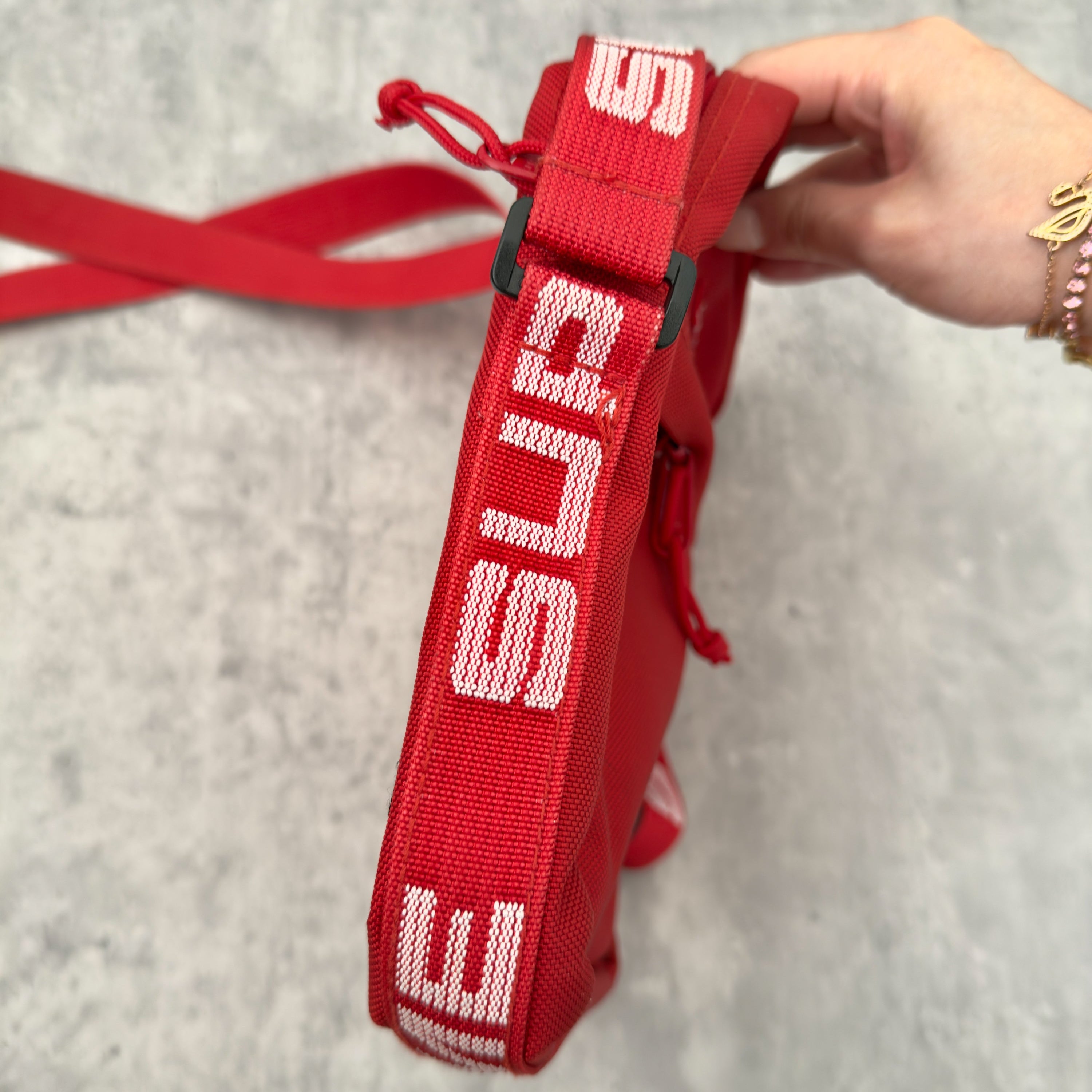 Supreme Shoulder Bag Red (SS18), made from Cordura® fabric with an adjustable Supreme-branded strap and zippered compartments.