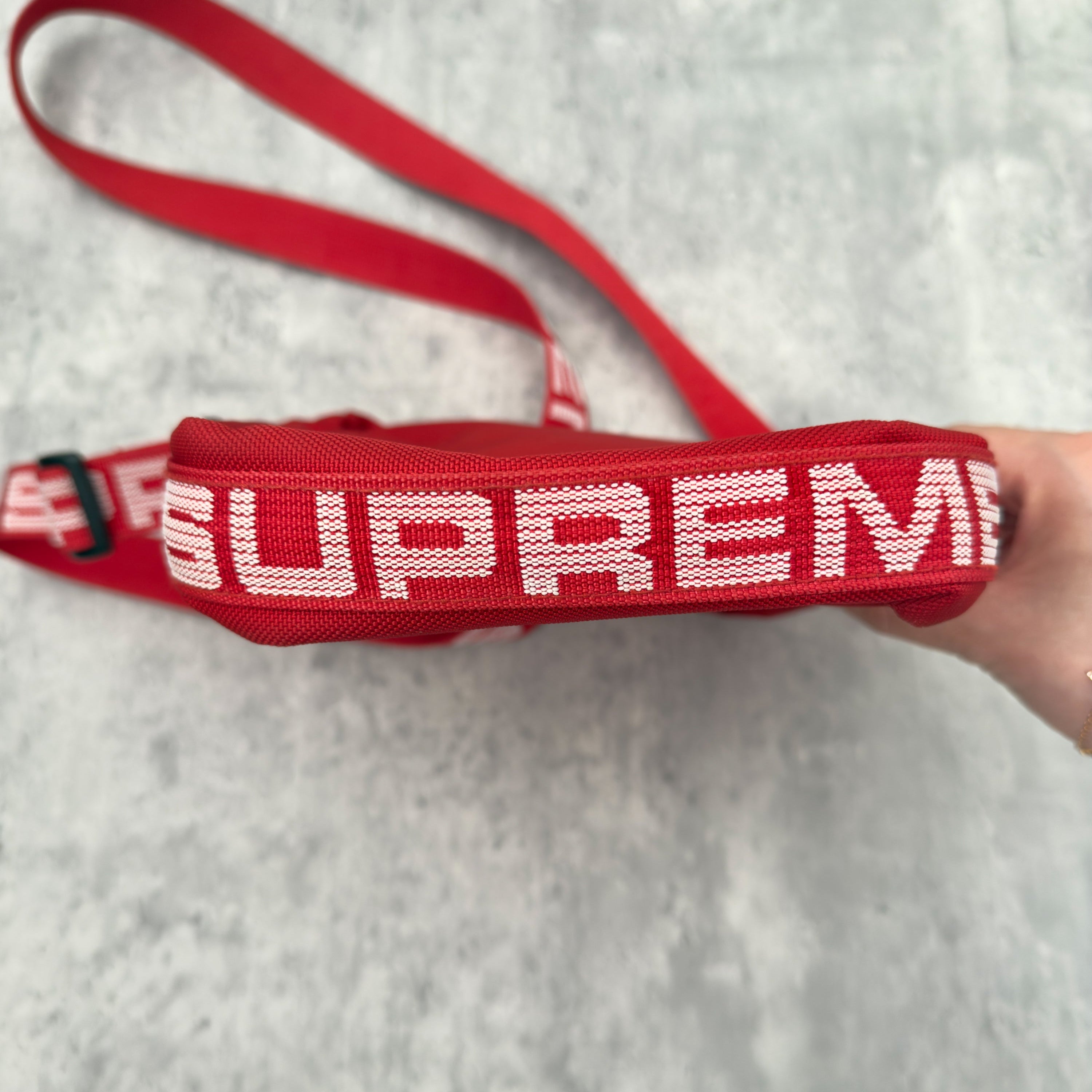 Supreme Shoulder Bag Red (SS18), made from Cordura® fabric with an adjustable Supreme-branded strap and zippered compartments.