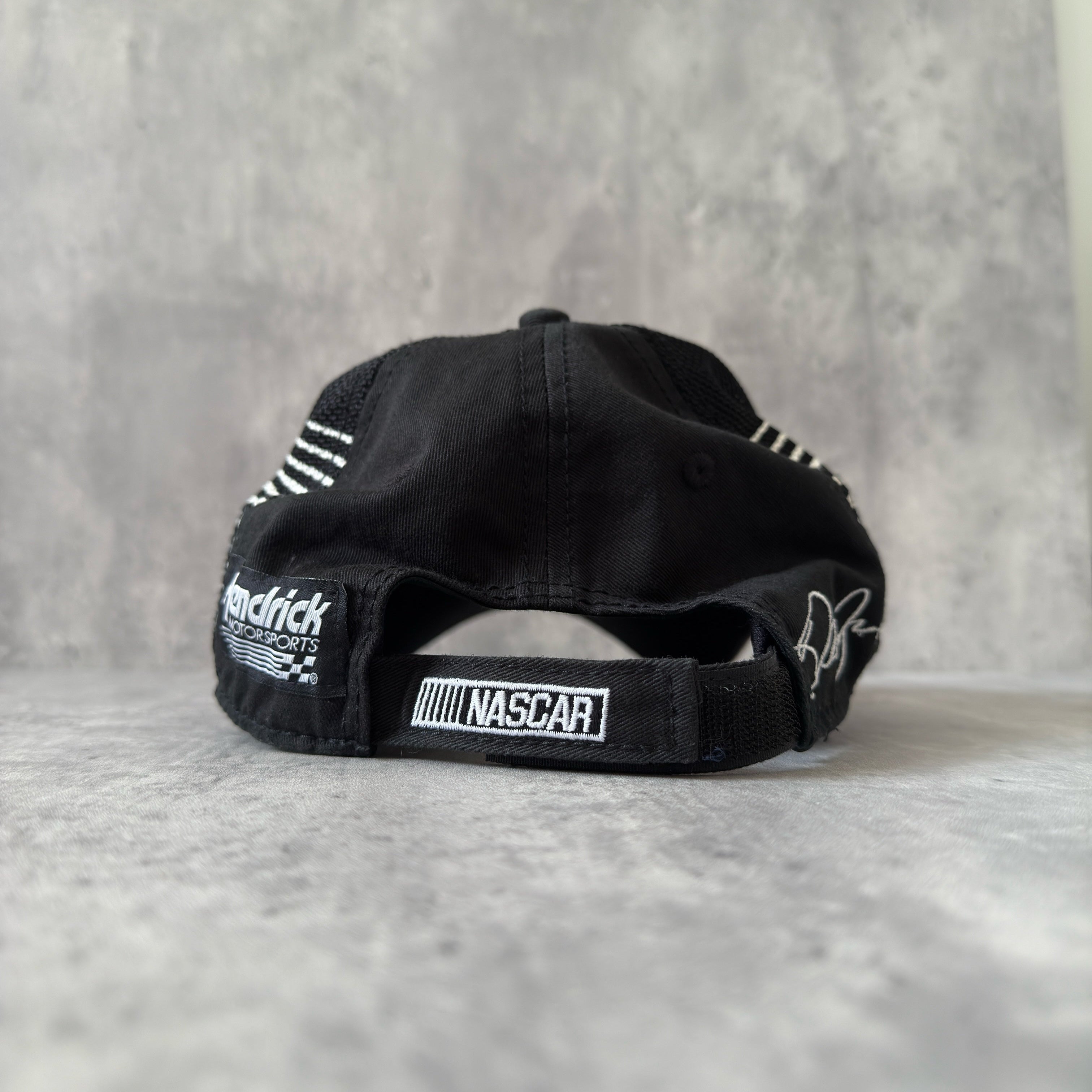 Dale Earnhardt Jr. 88 NASCAR Hendrick Strapback Hat in navy and black, featuring flame embroidery on the brim, Dale Jr.'s signature on the side, and an adjustable strapback closure.