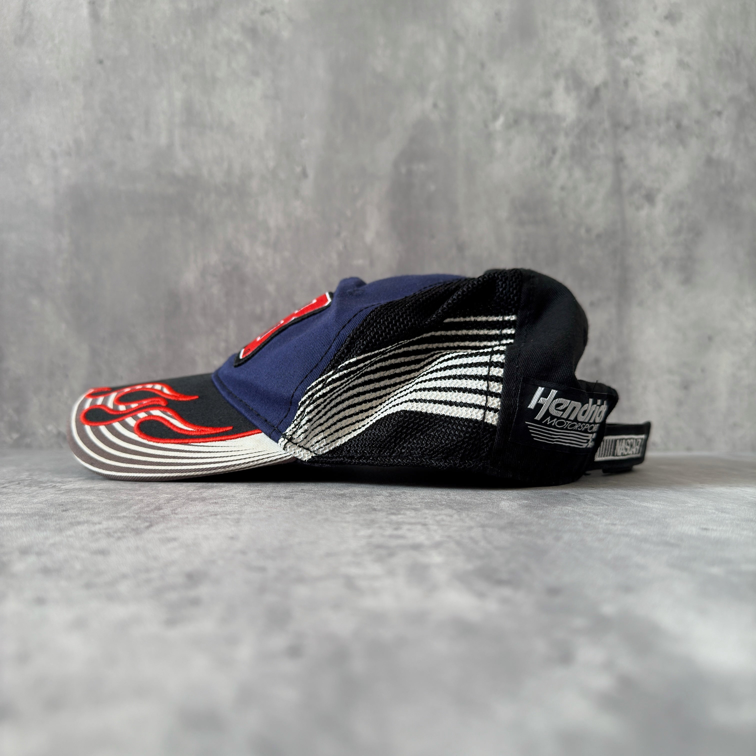 Dale Earnhardt Jr. 88 NASCAR Hendrick Strapback Hat in navy and black, featuring flame embroidery on the brim, Dale Jr.'s signature on the side, and an adjustable strapback closure.