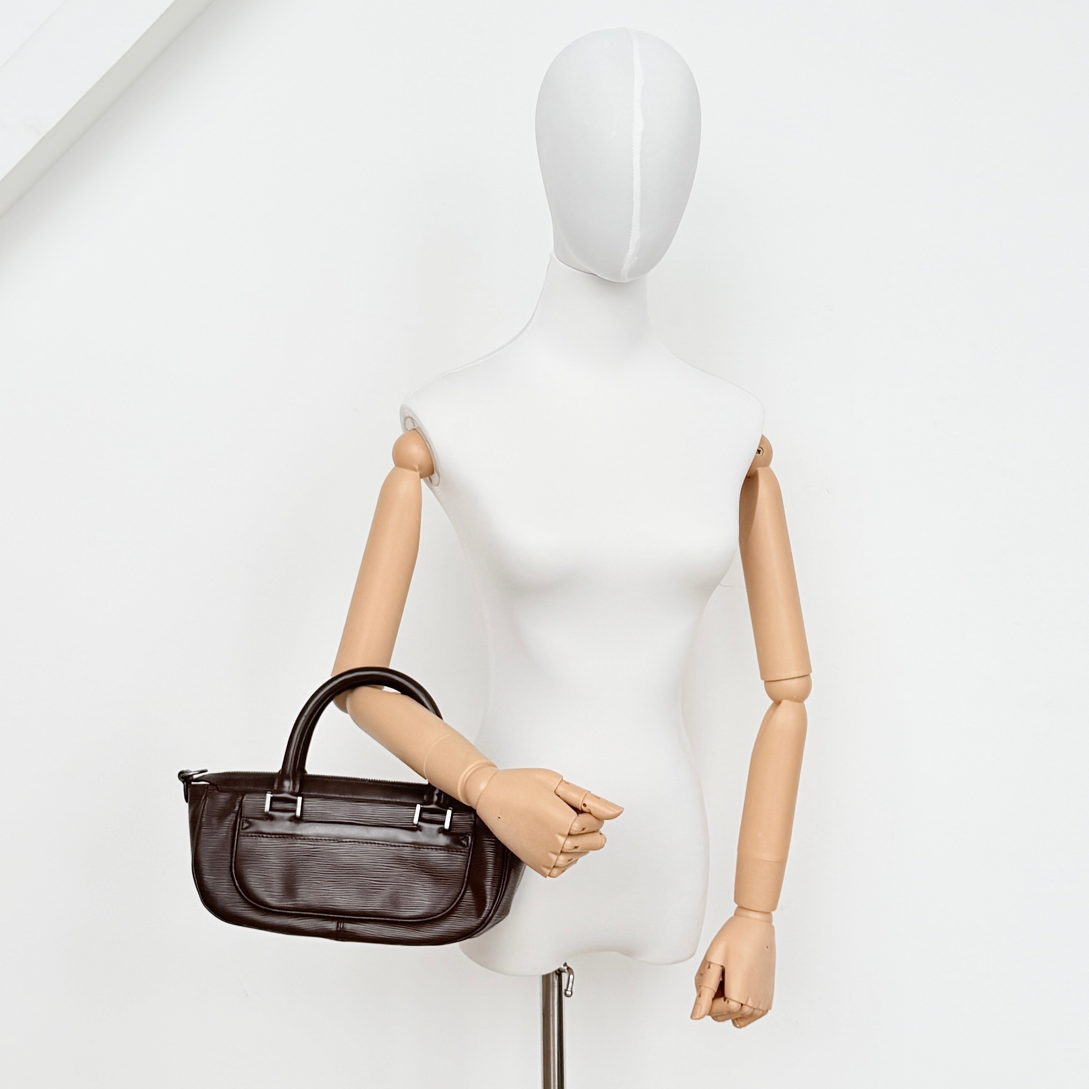 Louis Vuitton Dhanura PM 2Way shoulder bag in brown Epi leather with detachable strap and silver-tone hardware.