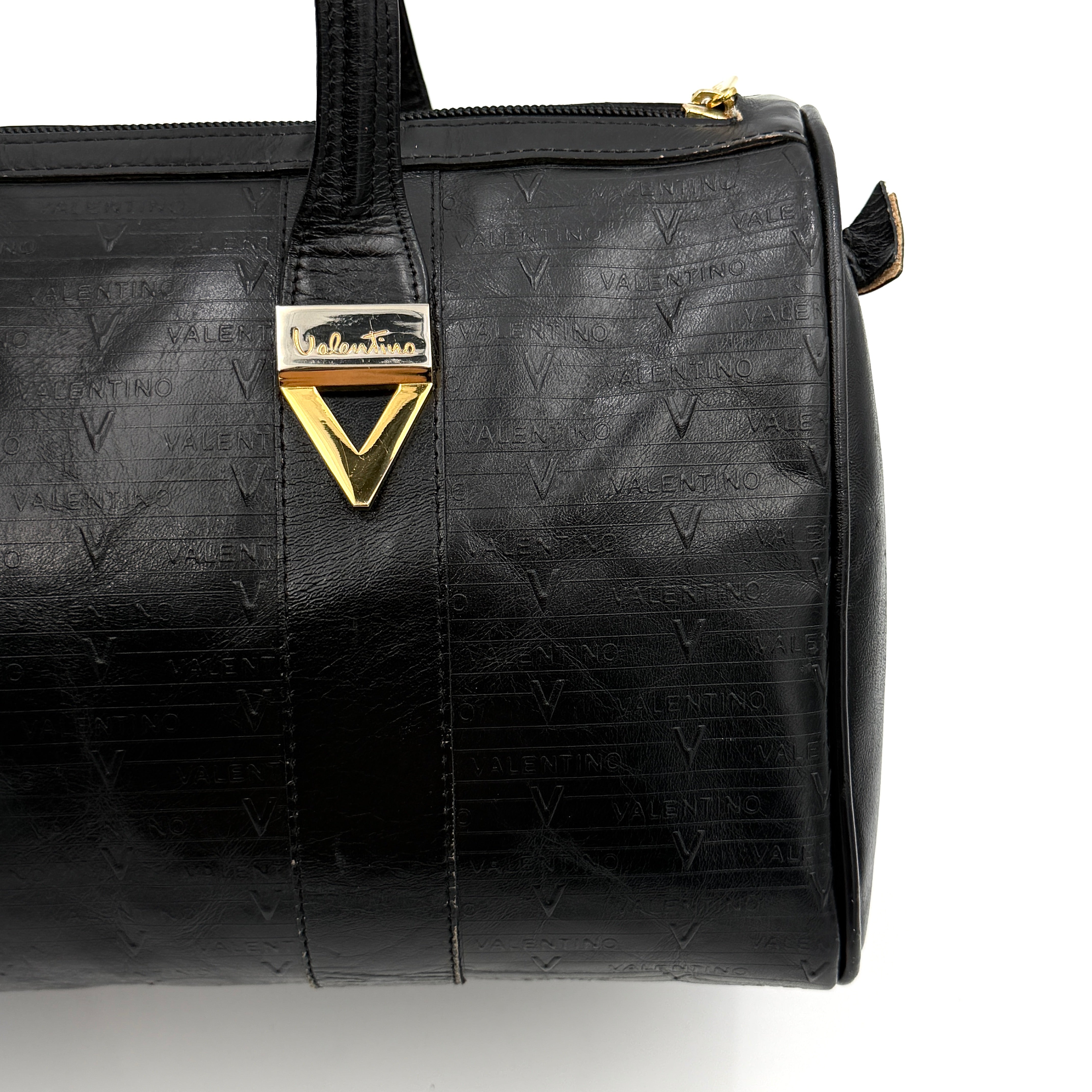 Valentino Monogram Boston Bag in black embossed leather with gold-tone V hardware and dual top handles.