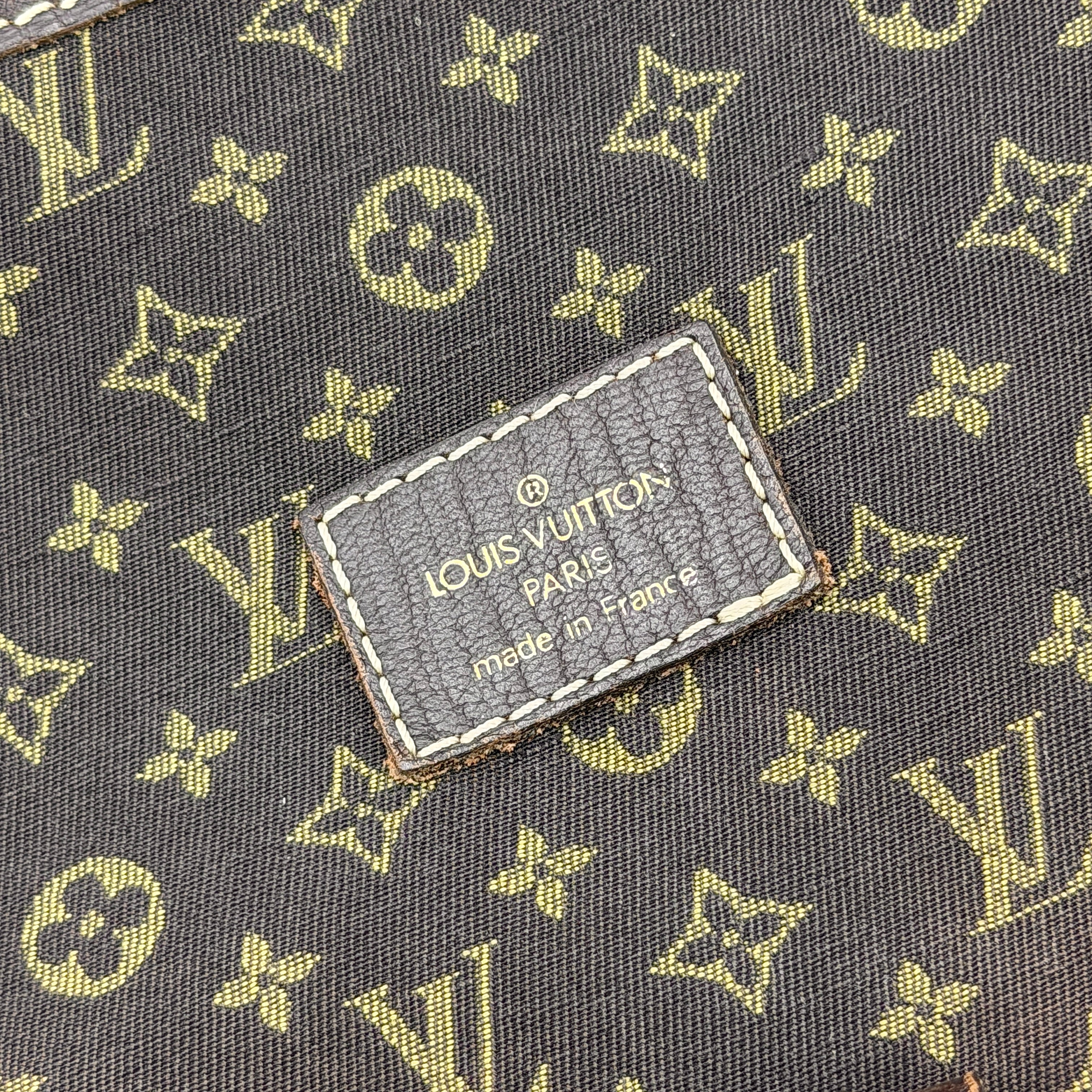 Louis Vuitton Monogram Mini Lin Saumur 30 in brown canvas with monogram pattern and leather buckled strap, photographed with the crossbody strap extended.