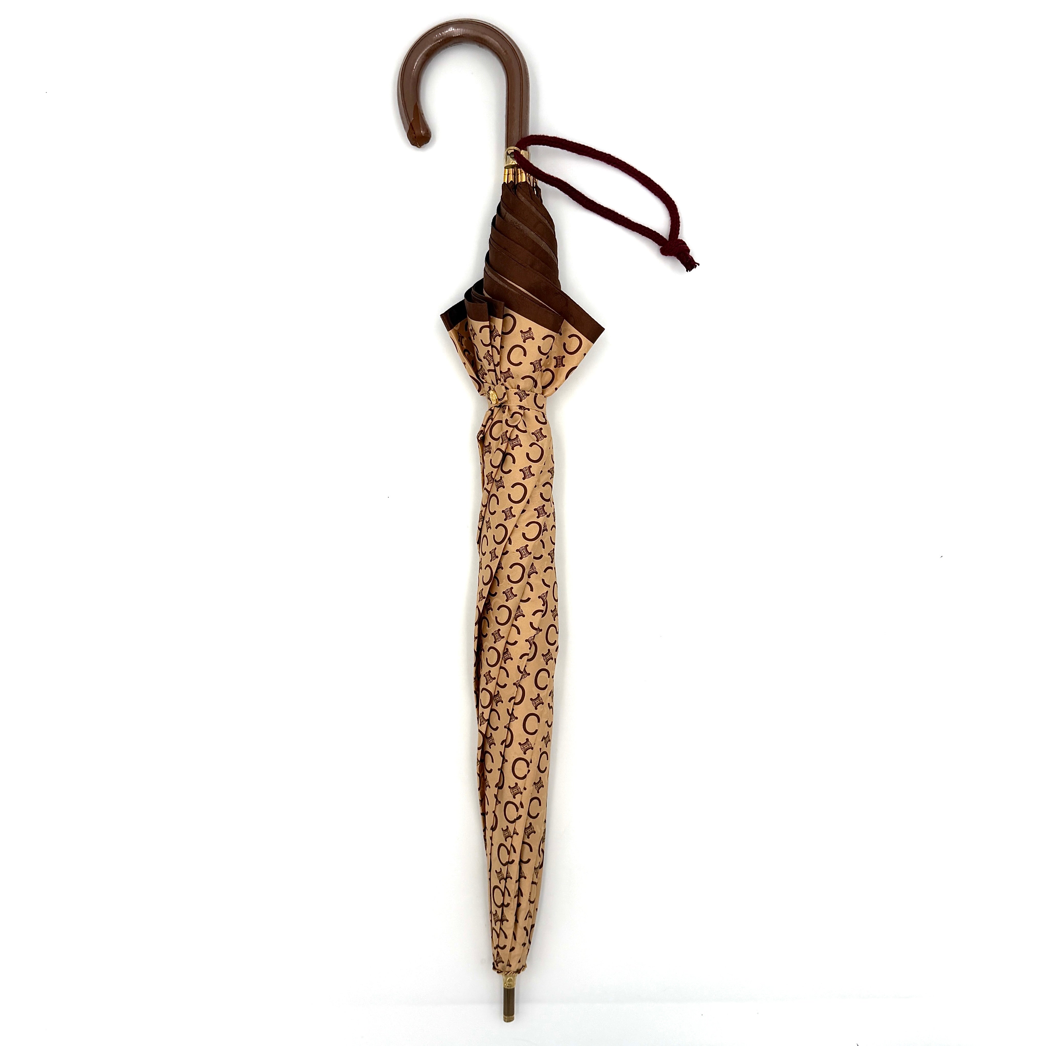 Celine Macadam Monogram Umbrella in brown and beige with classic curved handle and signature all-over logo pattern.
