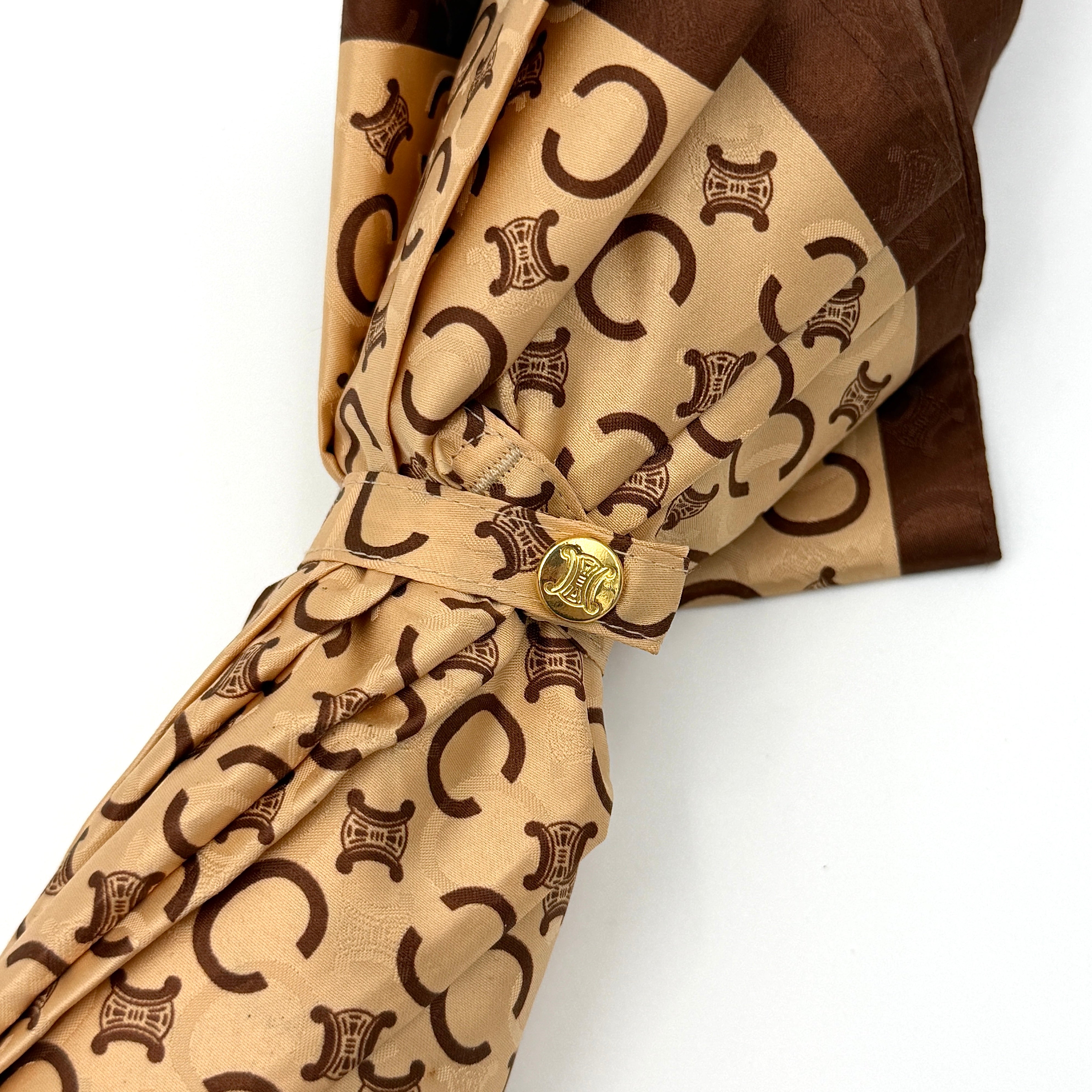 Celine Macadam Monogram Umbrella in brown and beige with classic curved handle and signature all-over logo pattern.