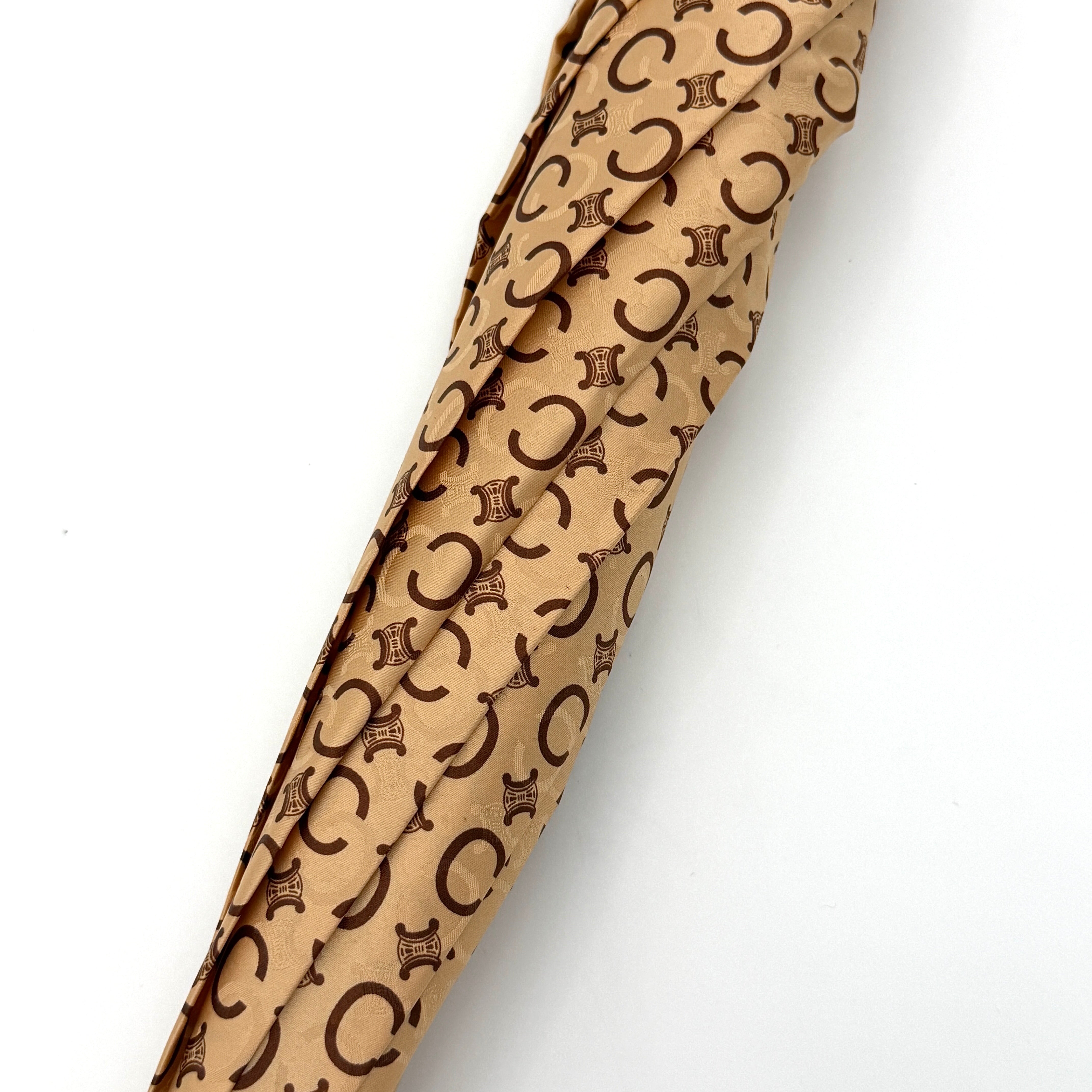 Celine Macadam Monogram Umbrella in brown and beige with classic curved handle and signature all-over logo pattern.