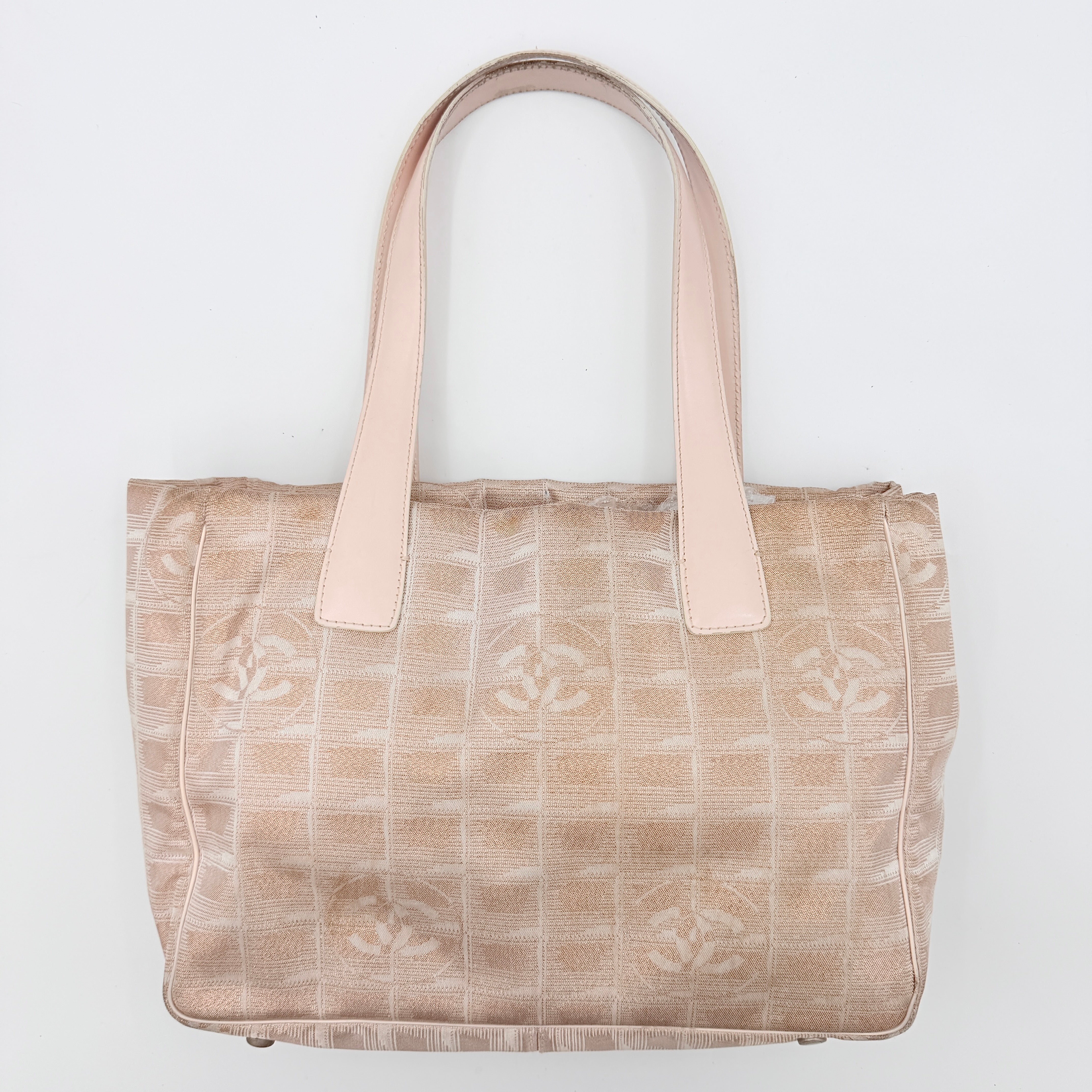 Chanel New Travel Line Tote Bag in rose gold jacquard with blush leather handles, displayed against a white background.
