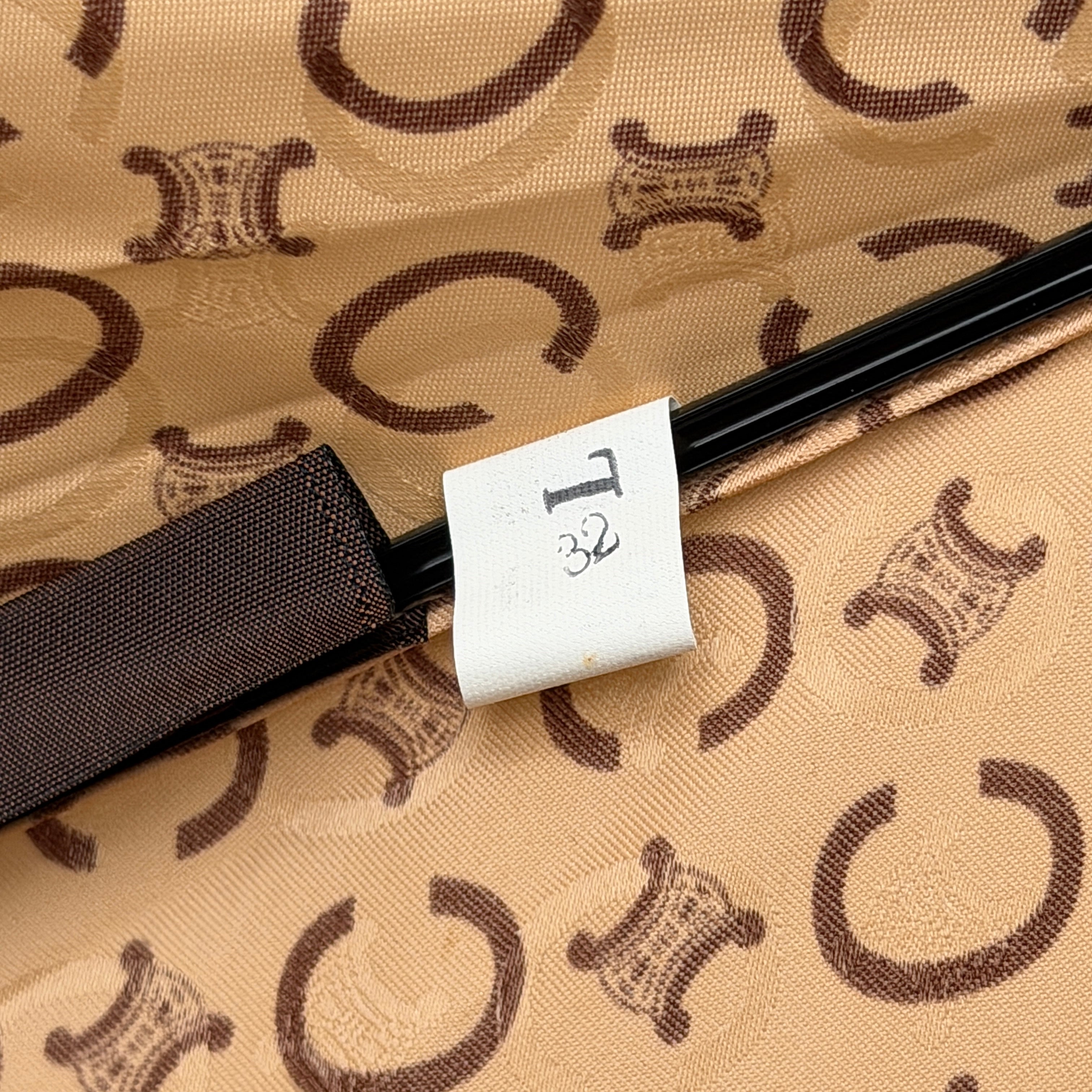 Celine Macadam Monogram Umbrella in brown and beige with classic curved handle and signature all-over logo pattern.