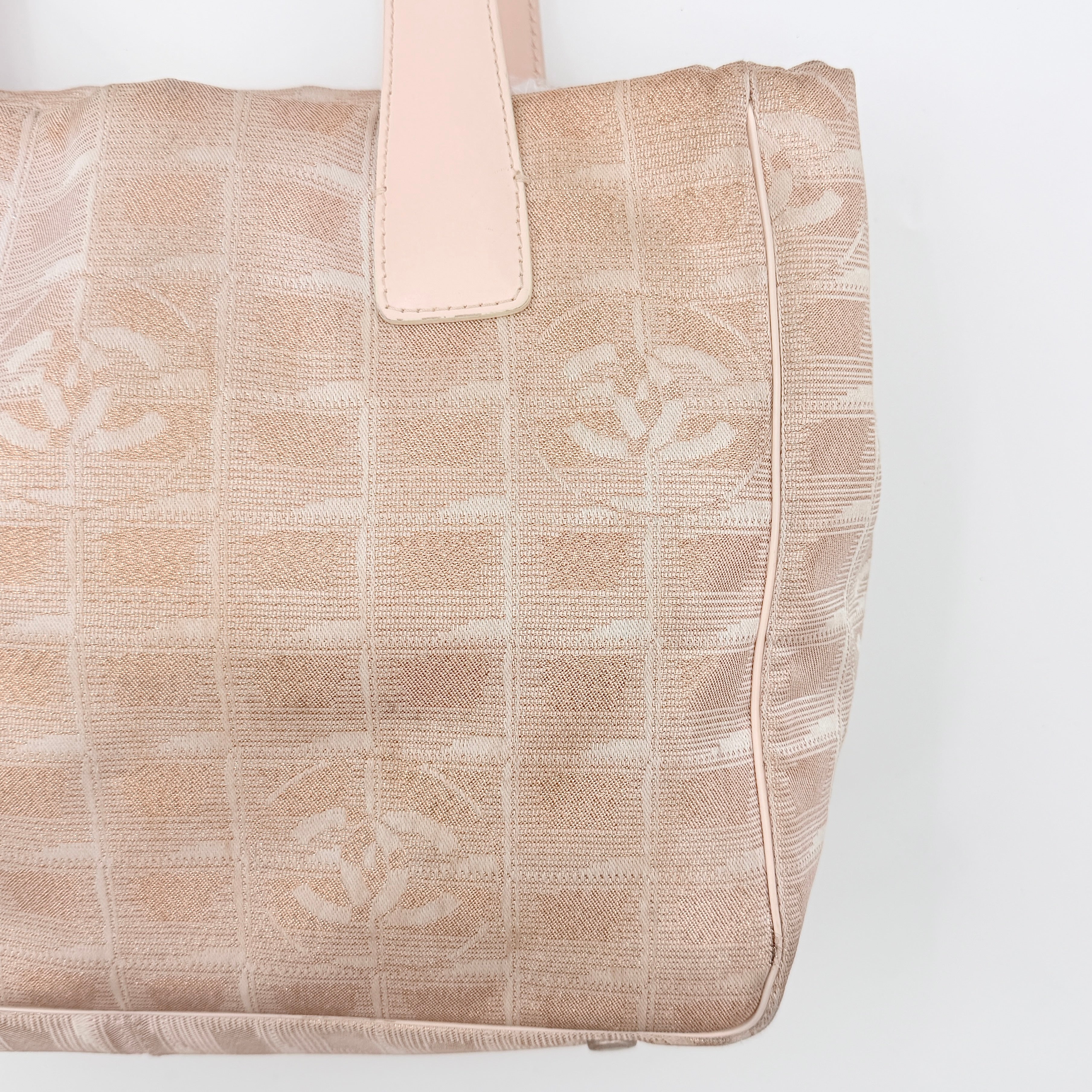 Chanel New Travel Line Tote Bag in rose gold jacquard with blush leather handles, displayed against a white background.