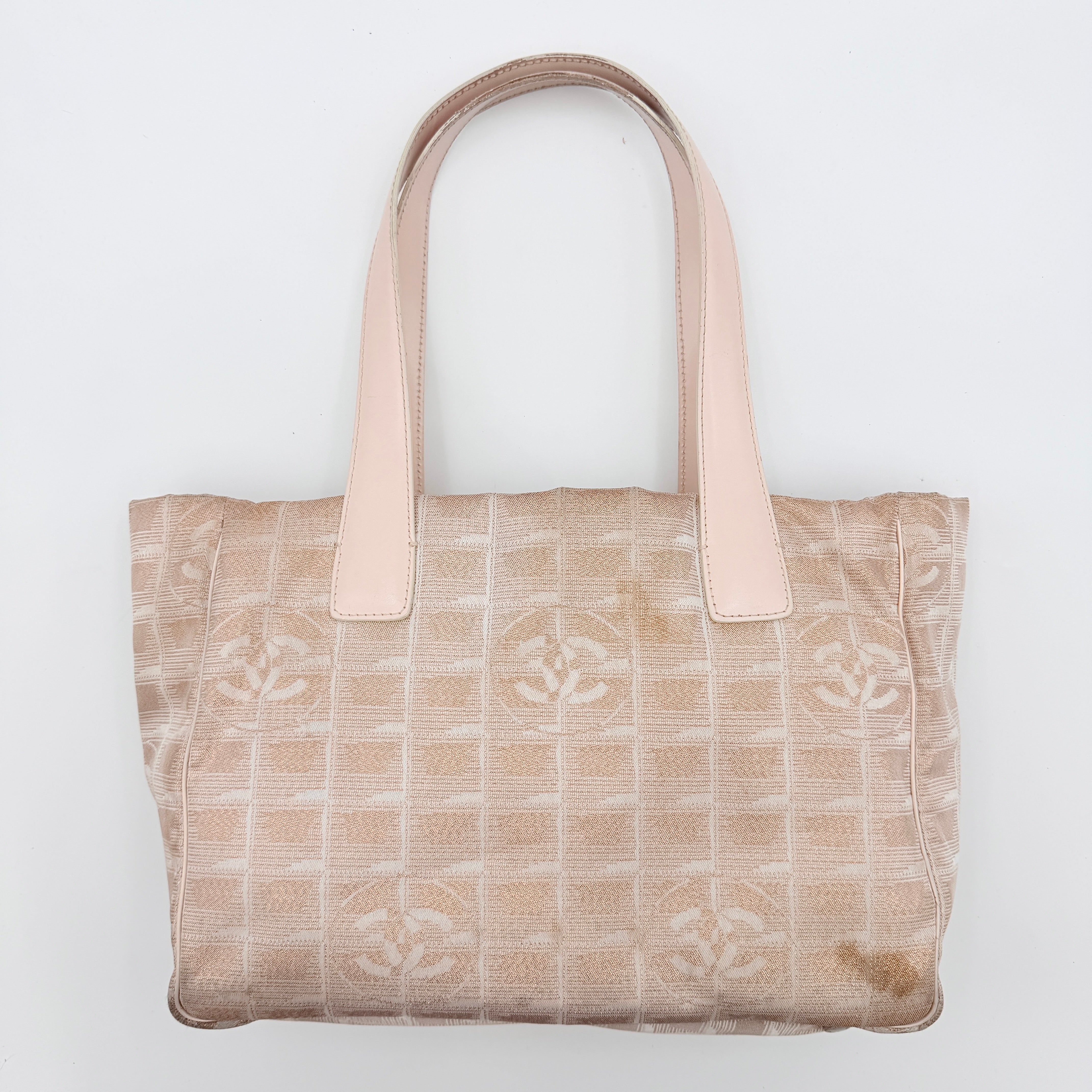 Chanel New Travel Line Tote Bag in rose gold jacquard with blush leather handles, displayed against a white background.