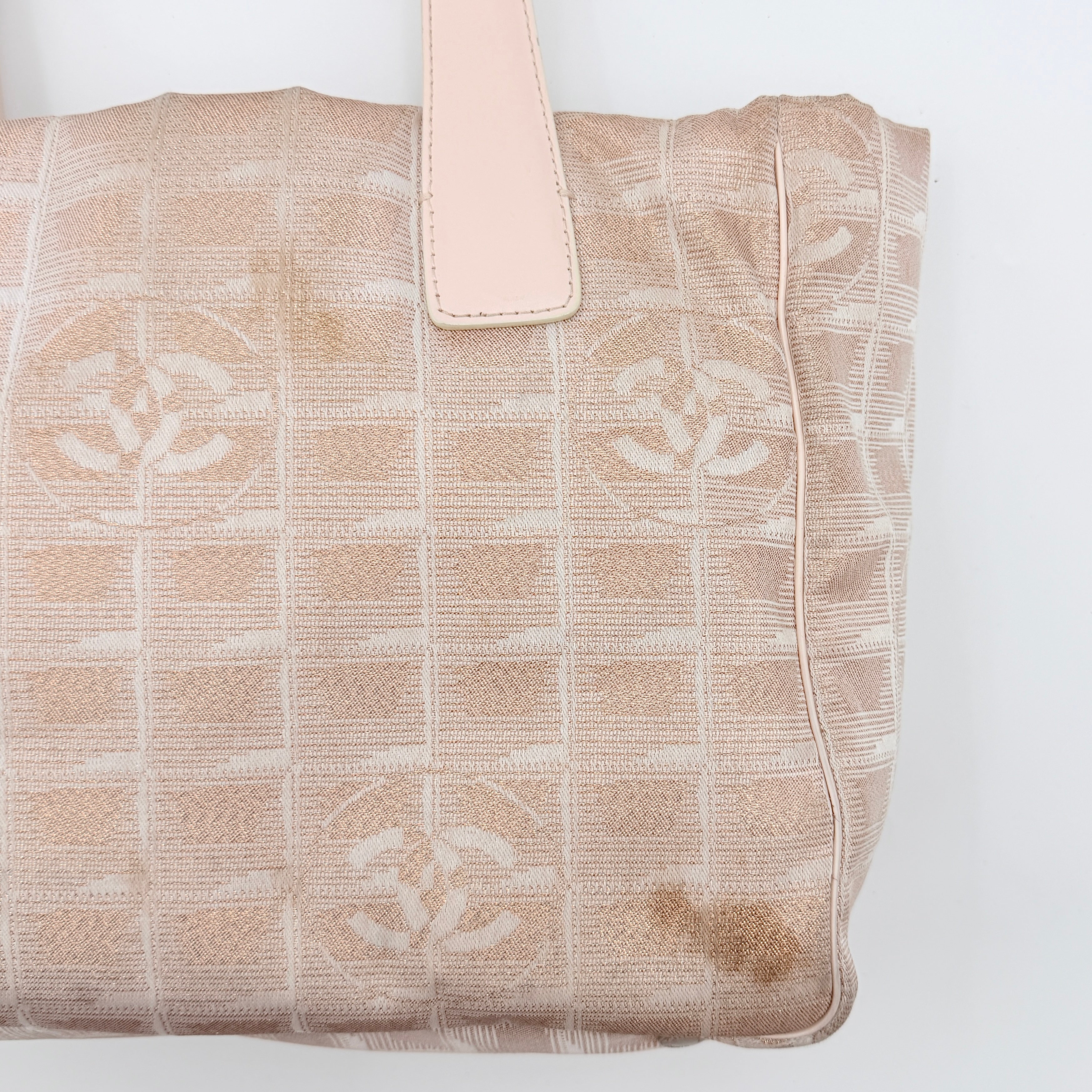 Chanel New Travel Line Tote Bag in rose gold jacquard with blush leather handles, displayed against a white background.
