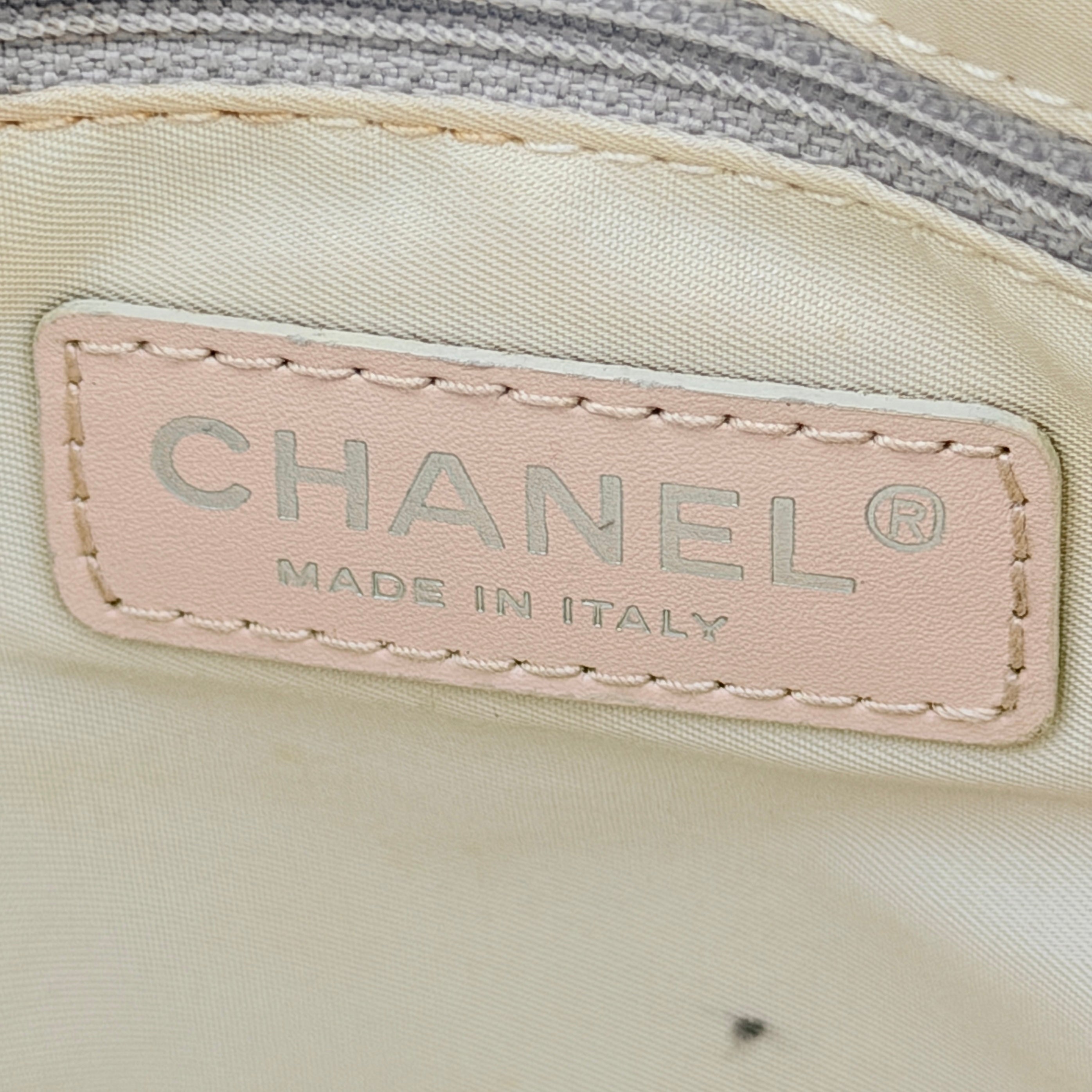 Chanel New Travel Line Tote Bag in rose gold jacquard with blush leather handles, displayed against a white background.