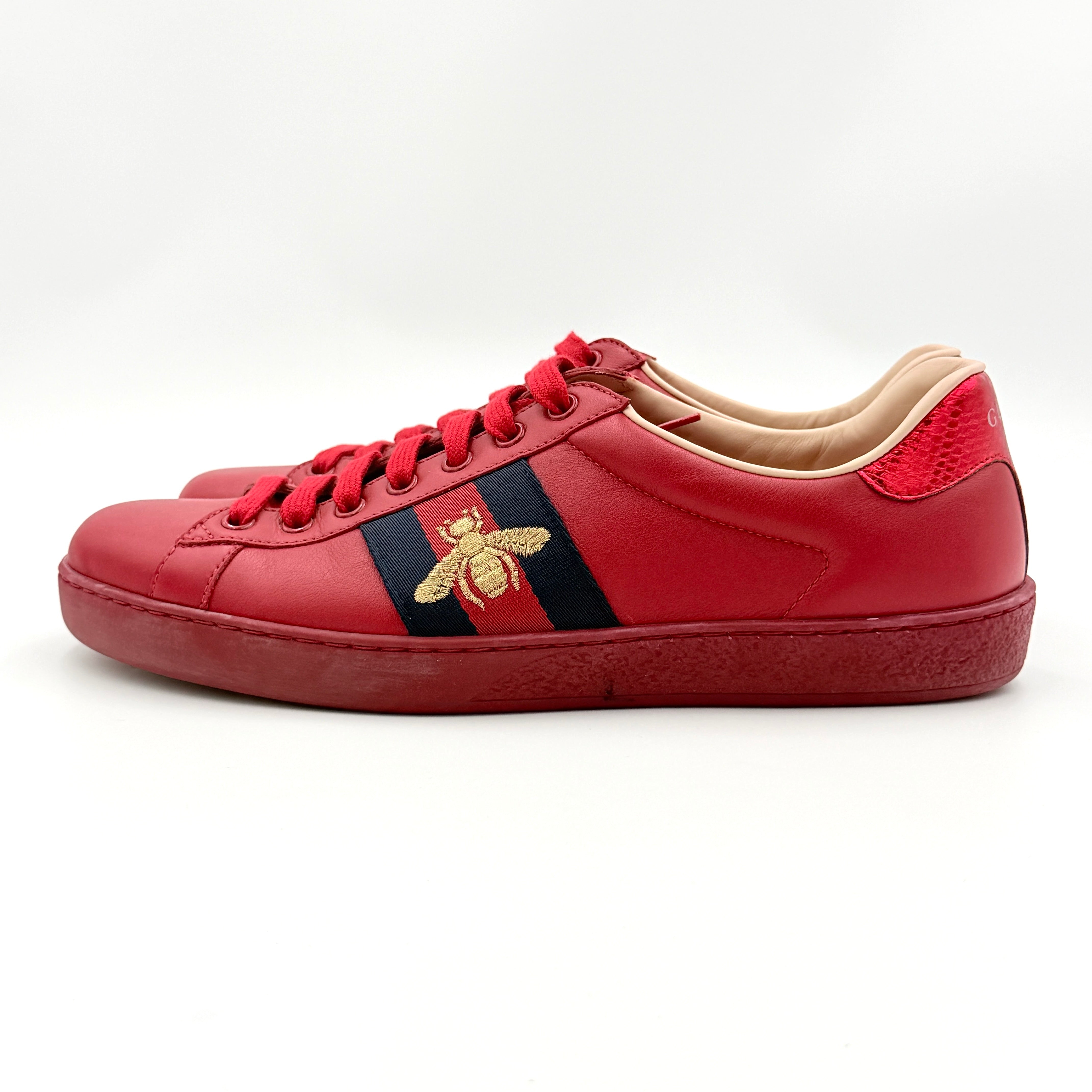 Gucci Ace Embroidered Bee sneakers in red leather with navy and red stripes and gold bee detail.