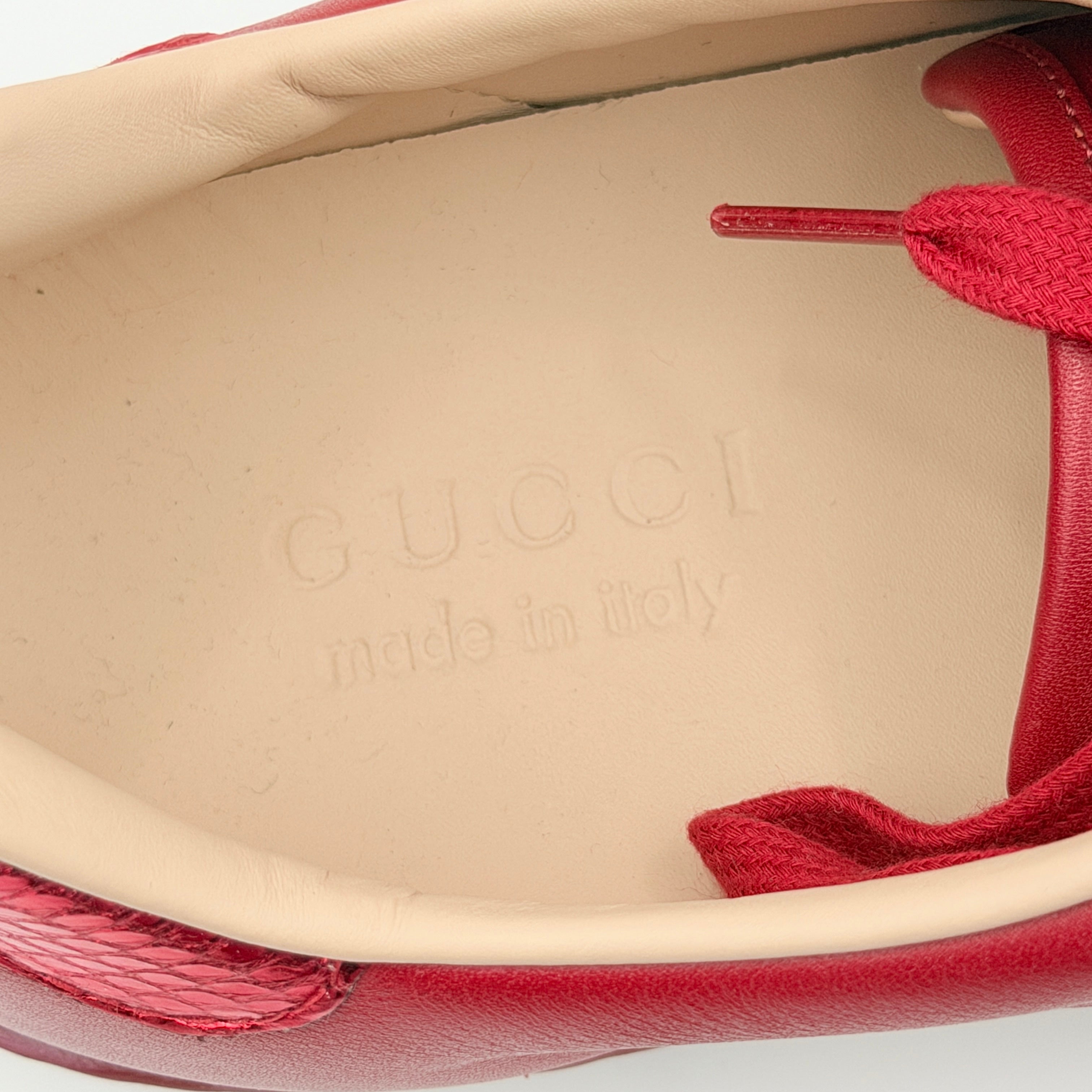 Gucci Ace Embroidered Bee sneakers in red leather with navy and red stripes and gold bee detail.